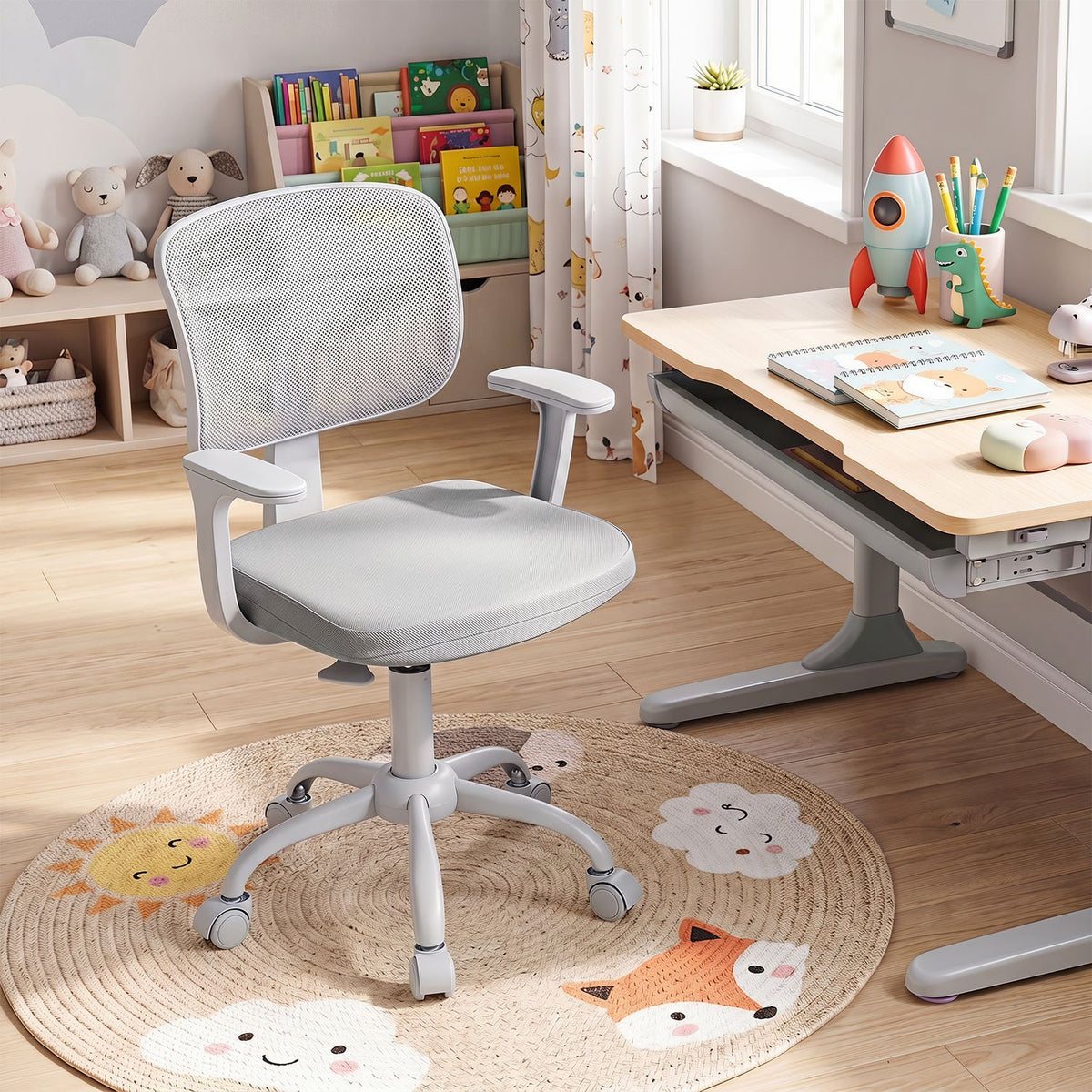 Gray swivel chair with mesh back and armrests in a children's study corner