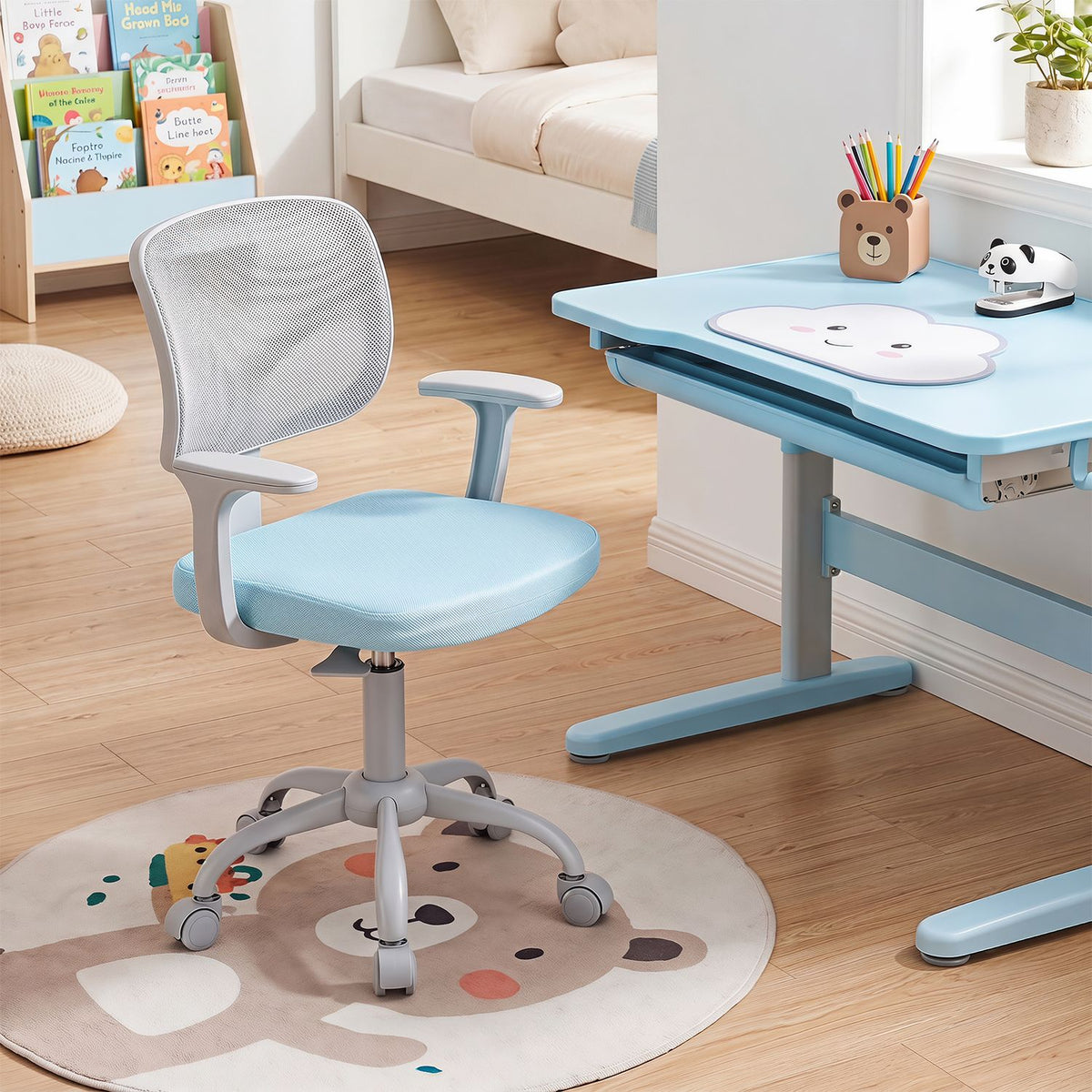 Light blue mesh-back chair with armrests beside a child’s desk in a bedroom.