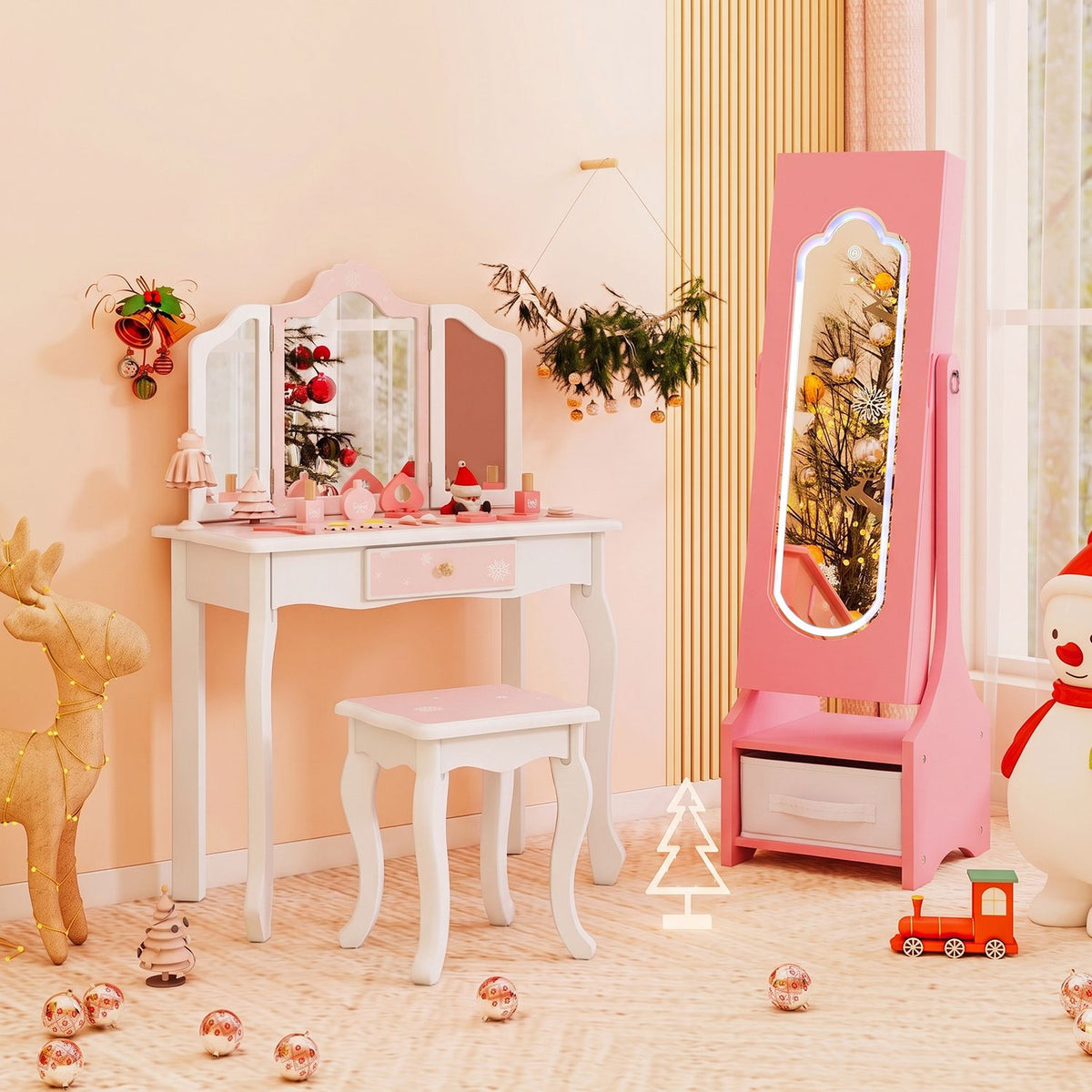 Pink full-length mirror jewelry armoire beside a white vanity and stool in a child’s room.
