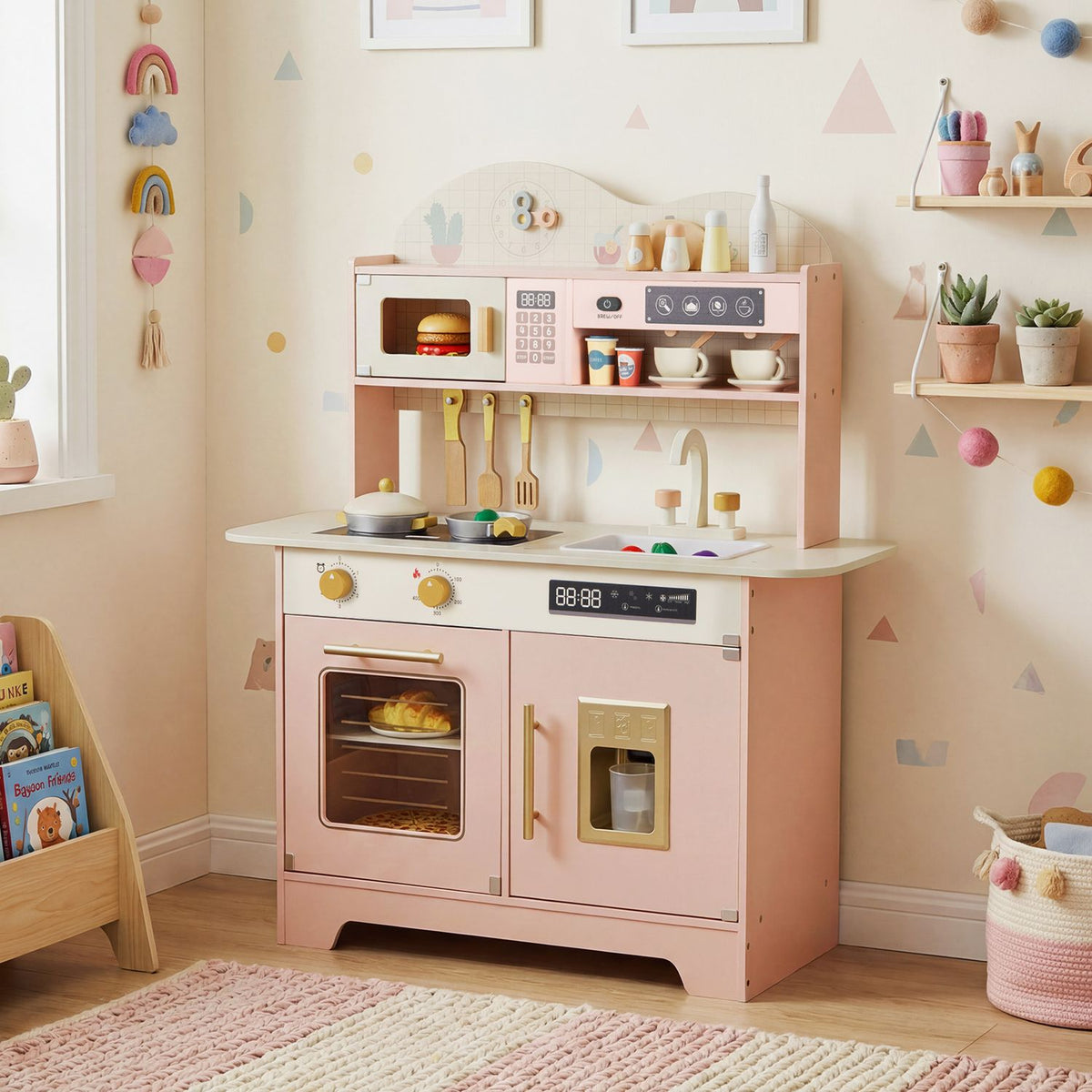 Pink toy kitchen displayed in a pastel playroom, with toy cookware on the stovetop and food in the oven.