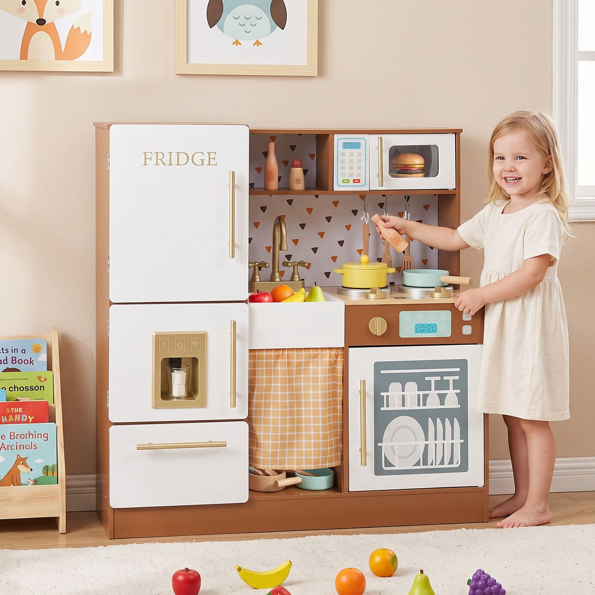 A child stands beside a play kitchen with pretend food and accessories on the counter and floor.