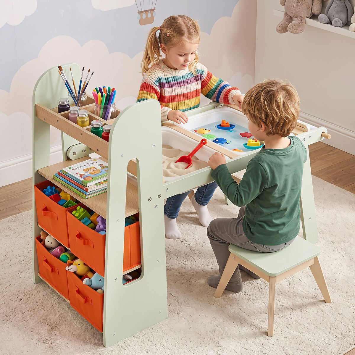 Two children use a pale green art table with colorful supplies and orange storage bins.