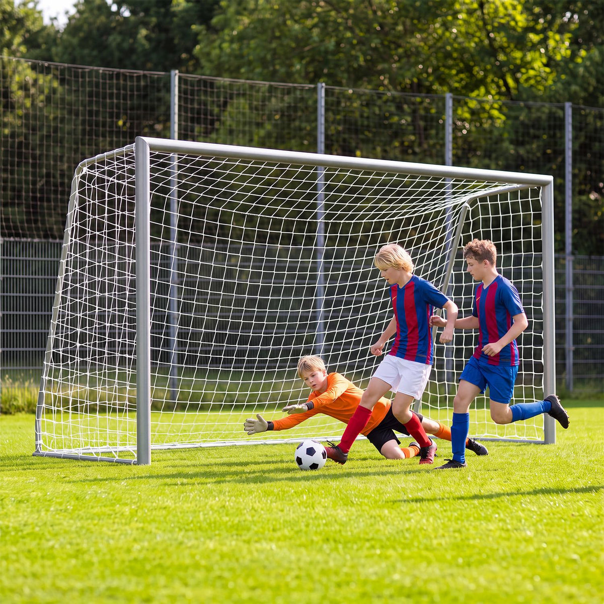 Three children play soccer in front of a goal as the goalkeeper reaches for the ball.