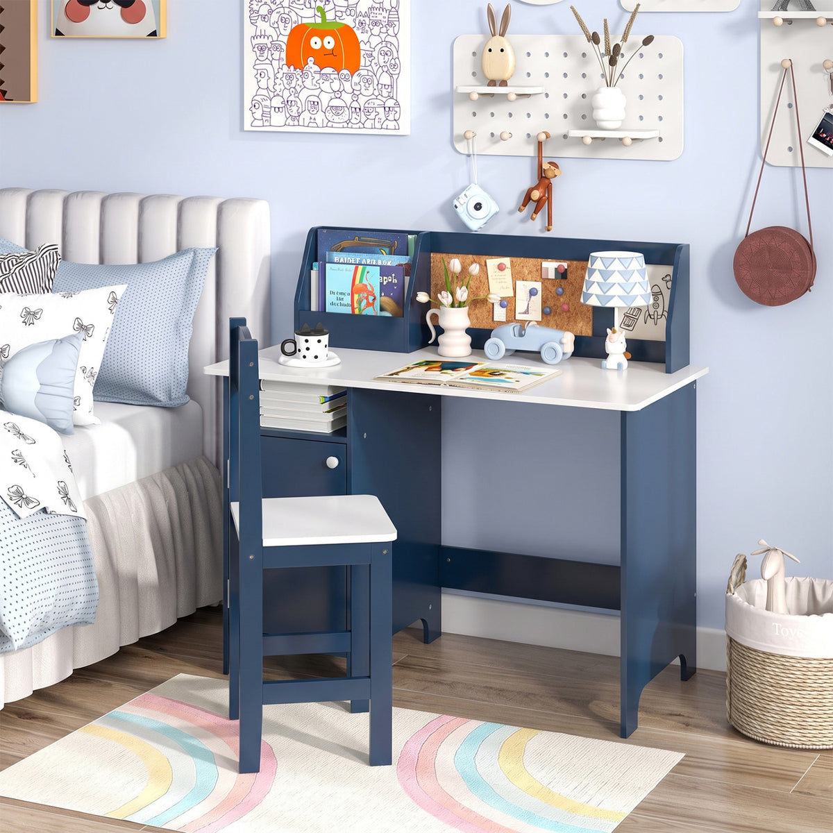Navy desk and matching chair beside a bed, styled with books and study supplies.