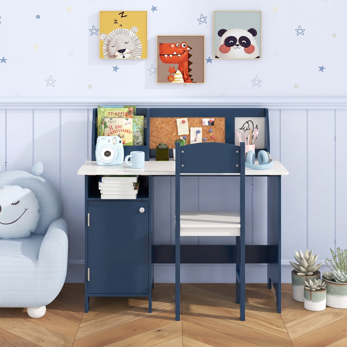 Blue children’s desk and chair set arranged in a bedroom, with books and supplies on the tabletop.