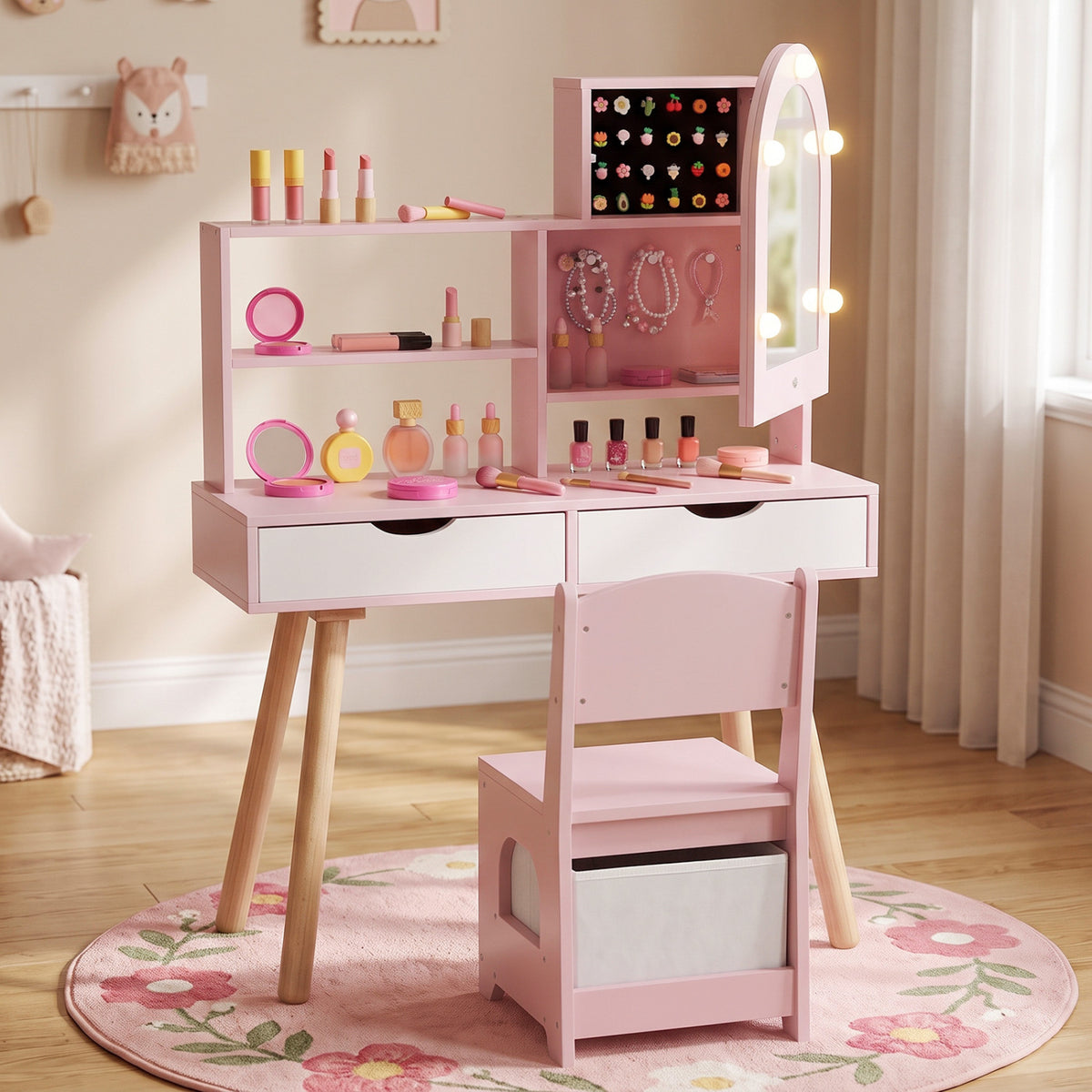Pink vanity and chair shown front-on on a floral rug, with cosmetics and jewelry displayed on the shelves.
