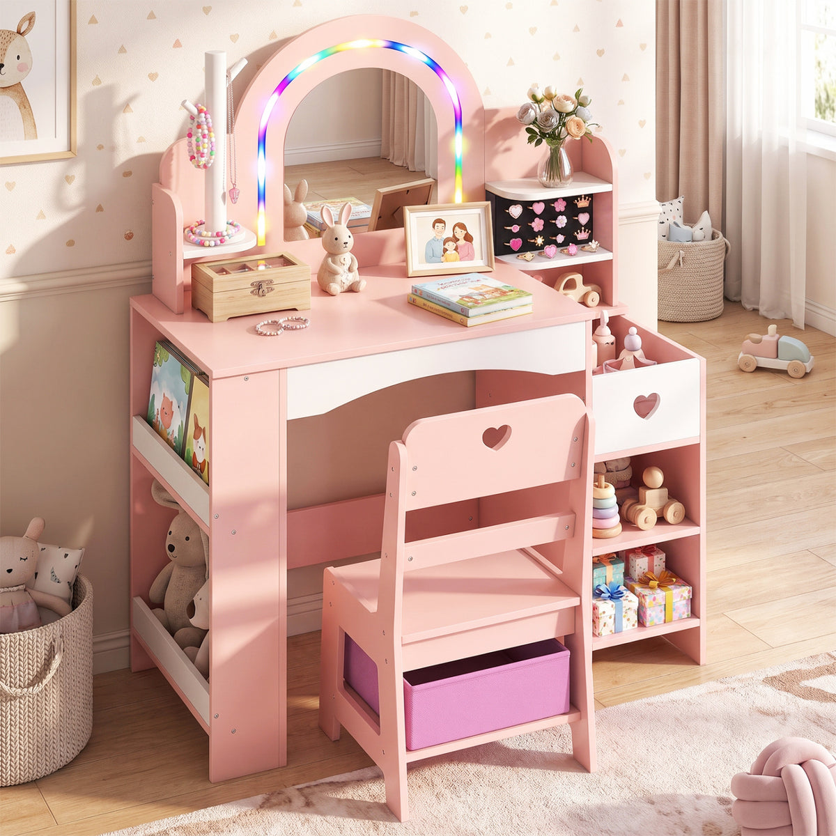 Pink child’s vanity and matching chair with an arched mirror, colorful lights, and a jewelry stand in a bright bedroom.