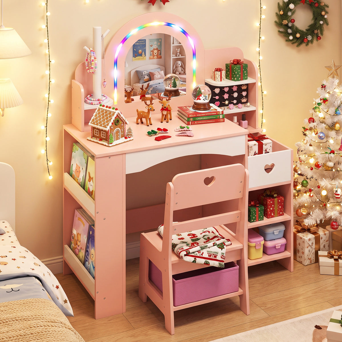 Pink vanity with an illuminated arched mirror and matching chair, styled with toys and holiday decorations.