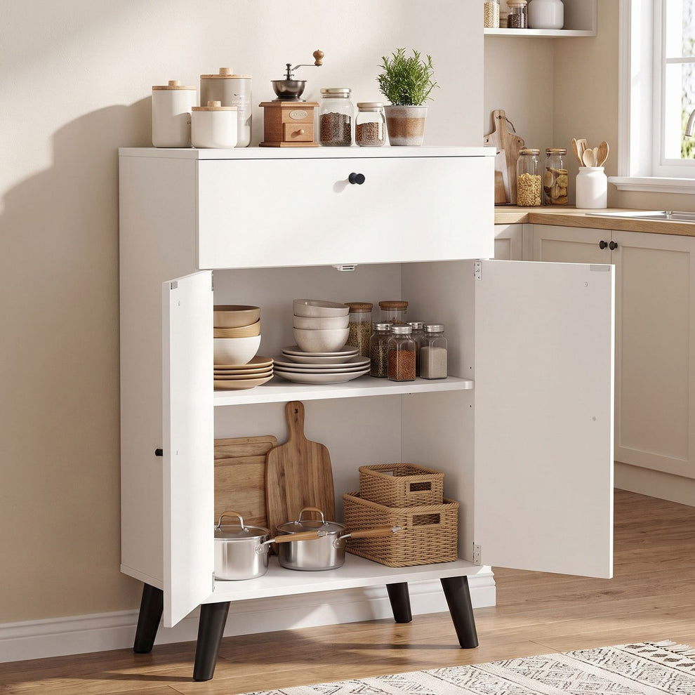 White cabinet with its drawer and both doors open, displaying dishes, jars, cookware and woven baskets.