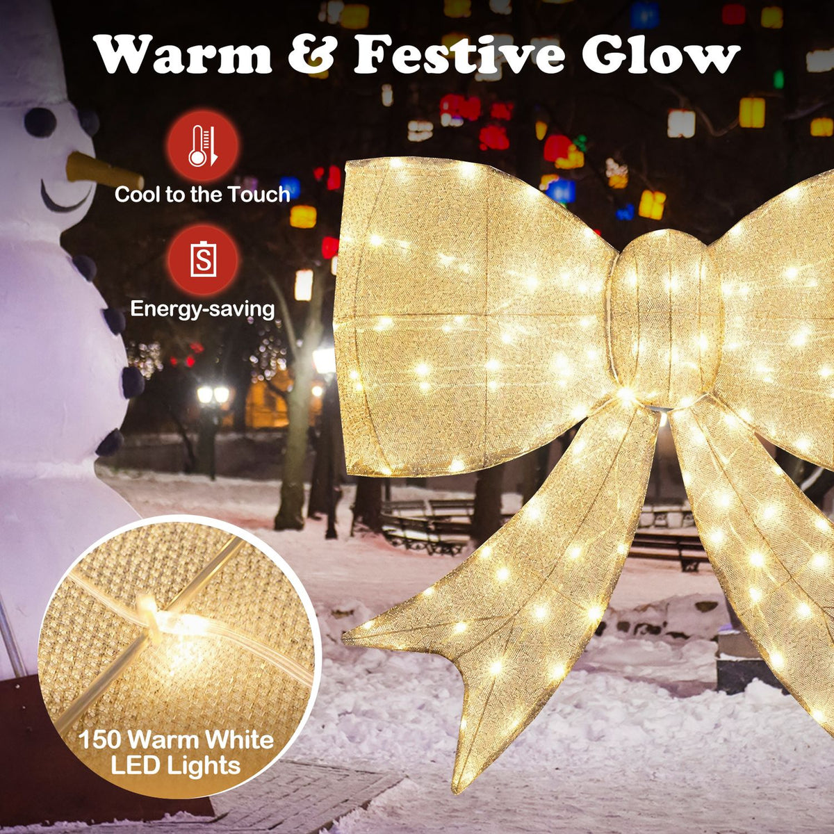 A lit golden bow fills the foreground of a snowy park scene, with a circular close-up of its fabric and lights.