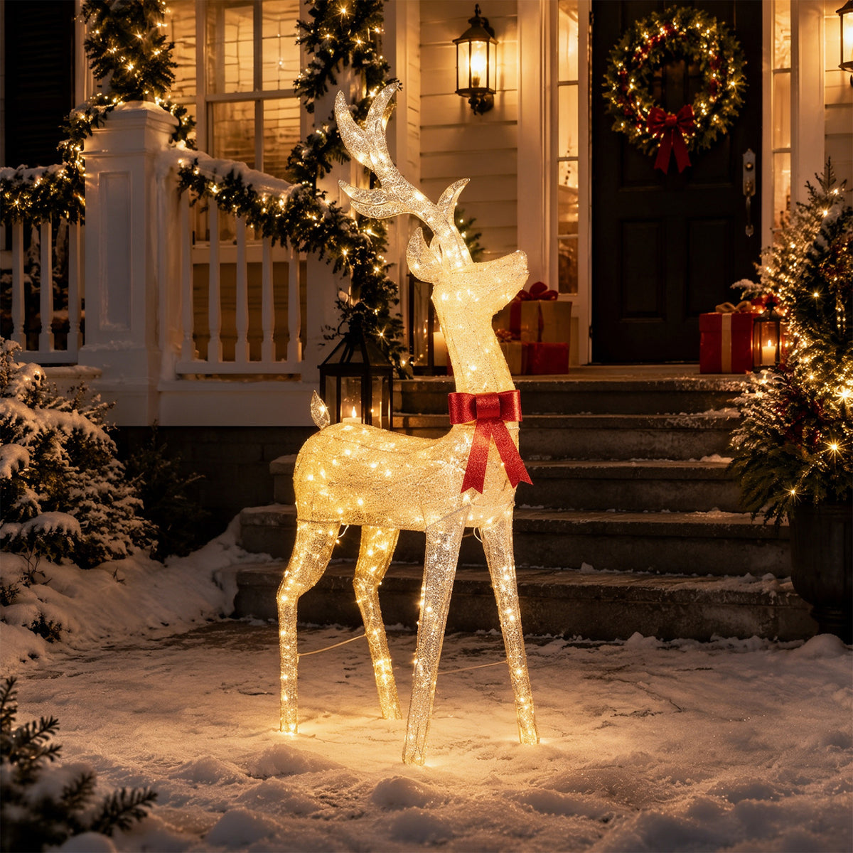 Glowing golden reindeer with a red bow stands in snowy stepside holiday decorations.