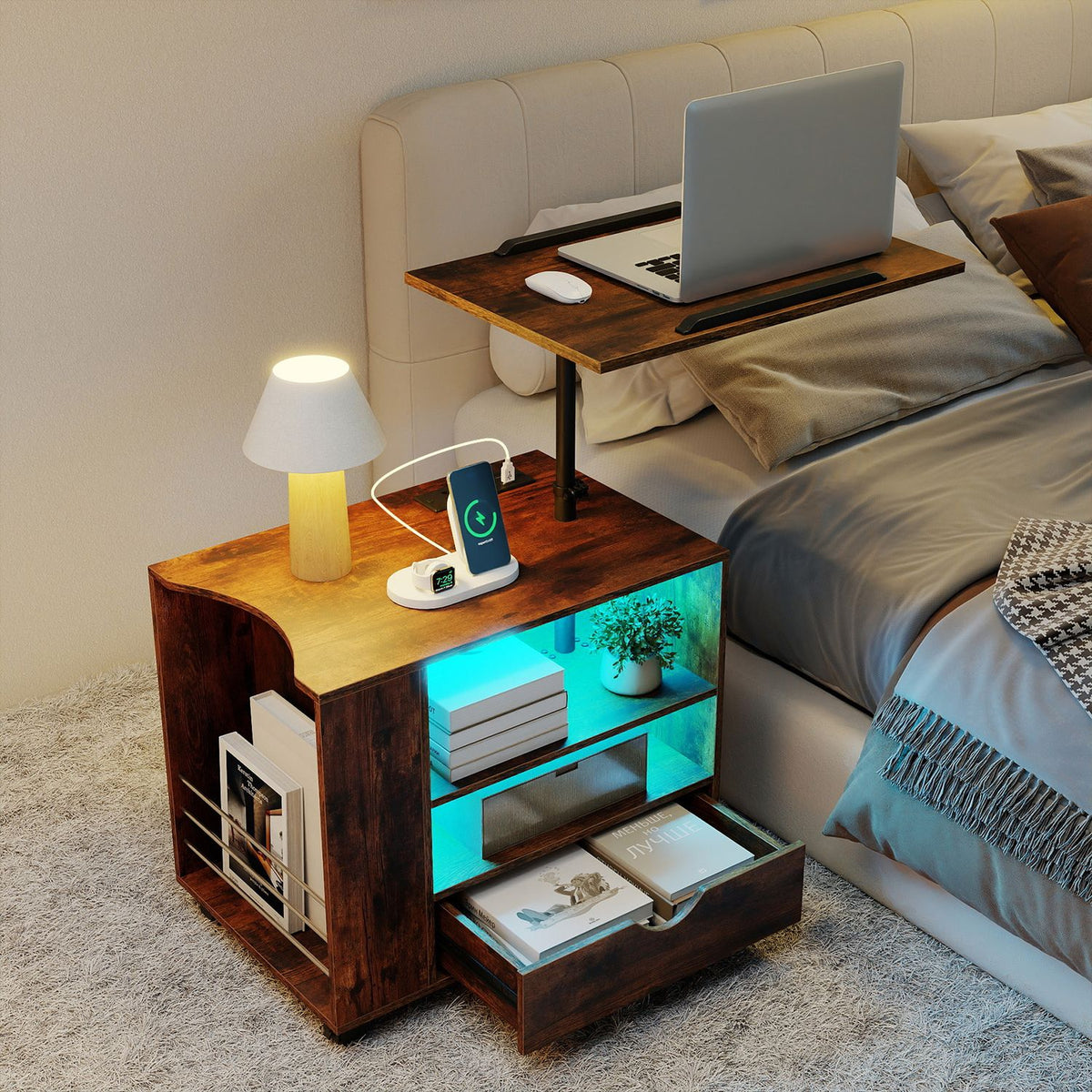 Dark brown rolling nightstand beside a bed with raised laptop tray and illuminated storage