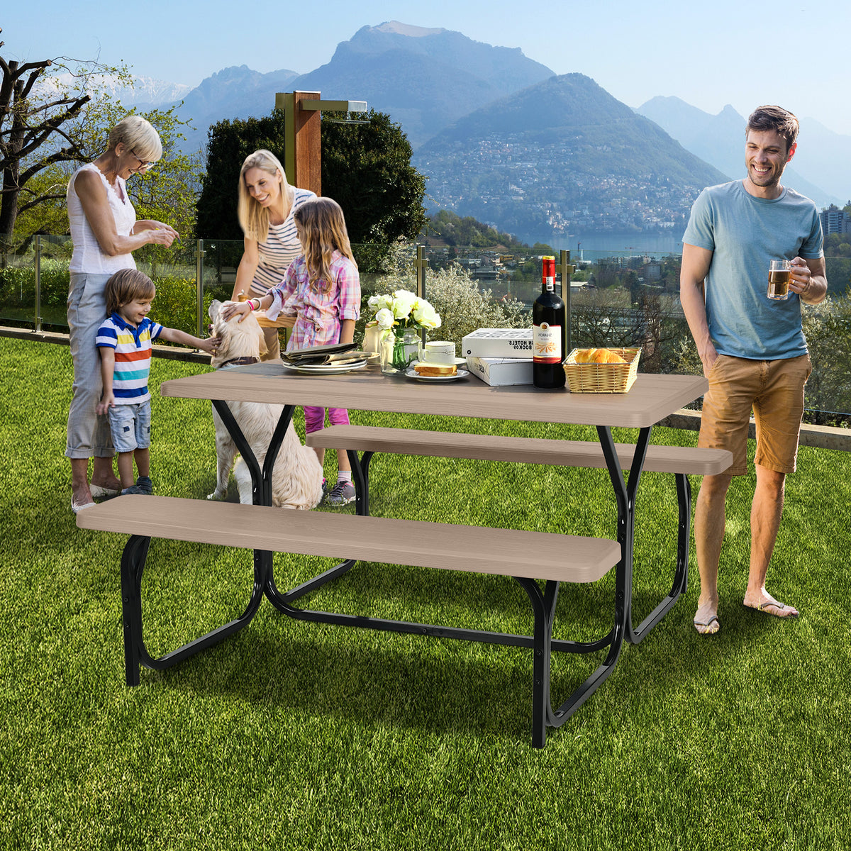 A family gathers around a brown picnic table with matching benches on a grassy lawn.