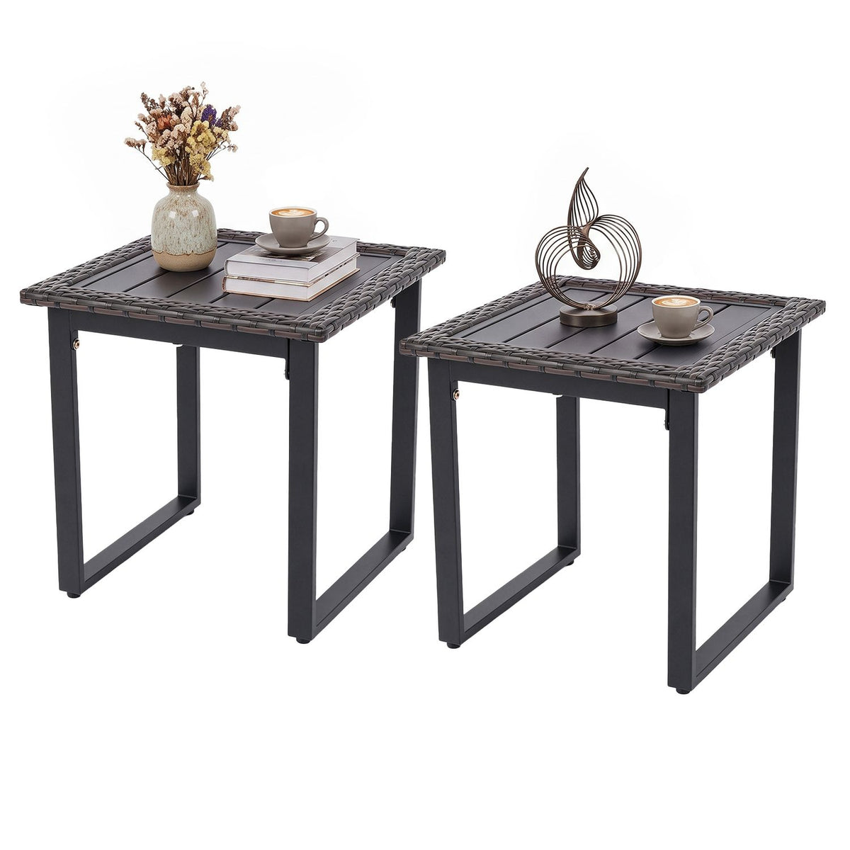 Two dark woven-edge side tables styled with a vase, books, cups, and a metal ornament.