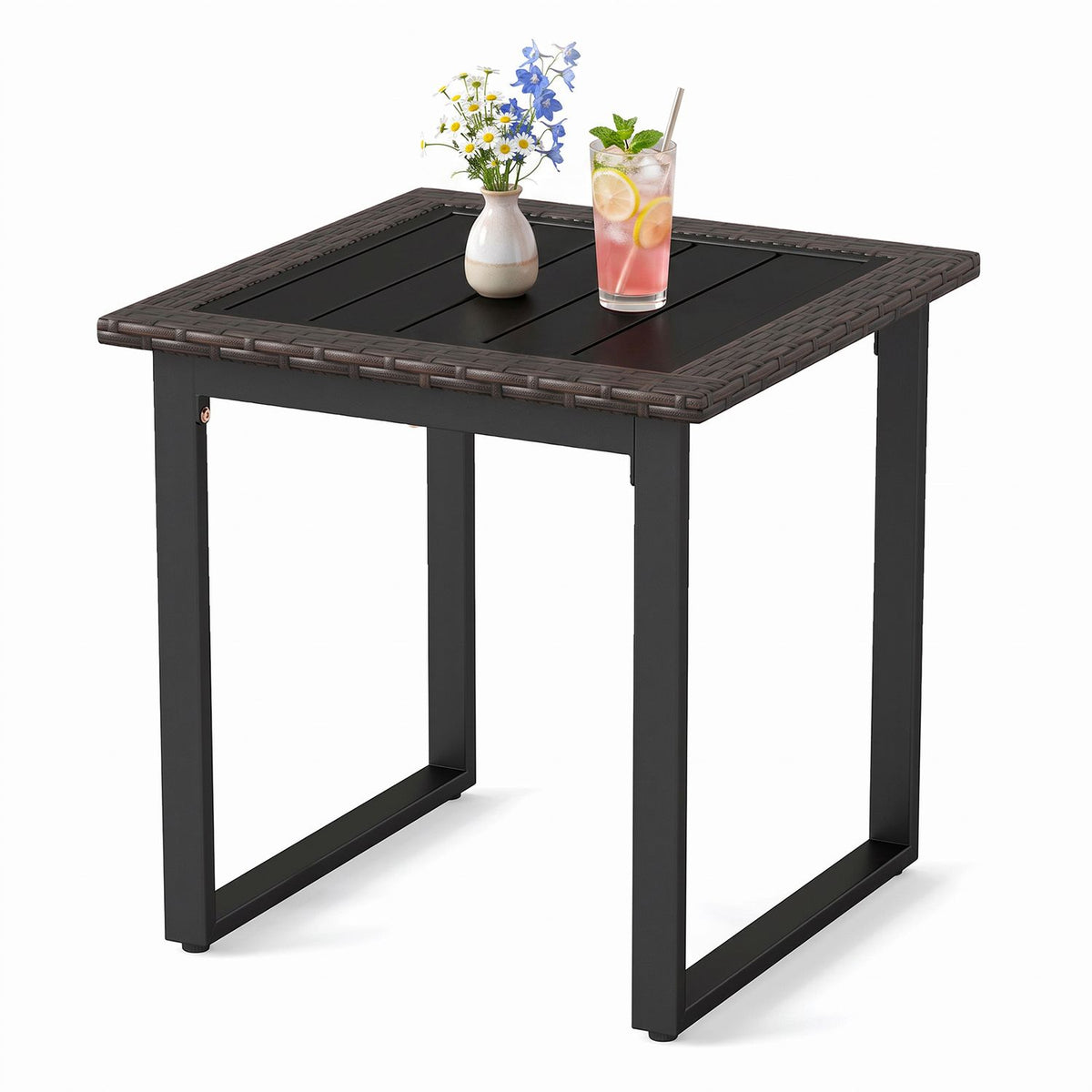 Square side table with a woven border and slatted top, styled with a vase of flowers and a drink.