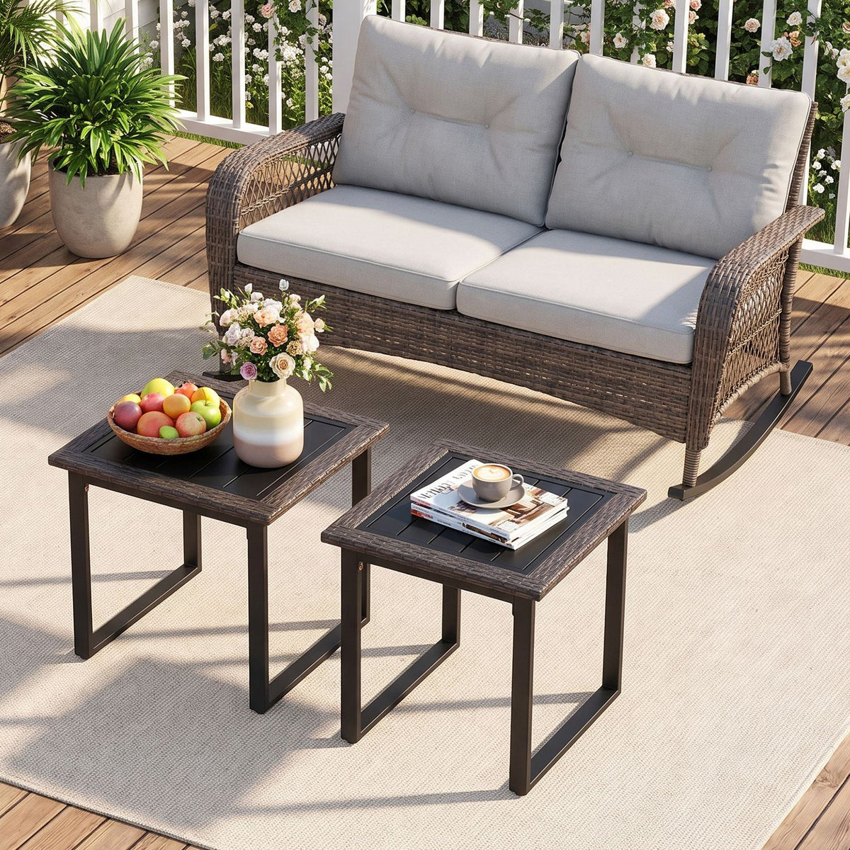 Two dark woven side tables sit on a patio rug in front of a cushioned outdoor sofa.