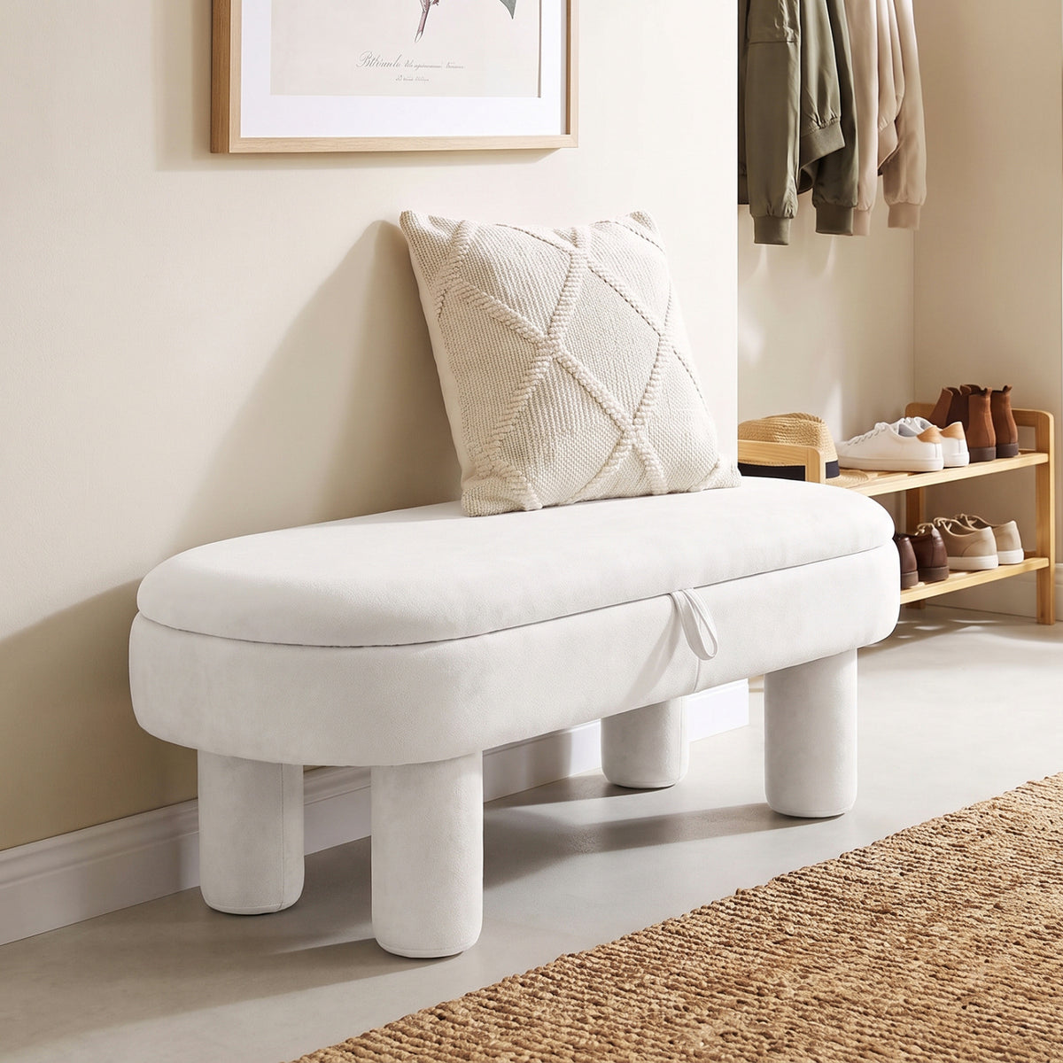 White oval storage ottoman bench beside a shoe rack in a bright entryway.