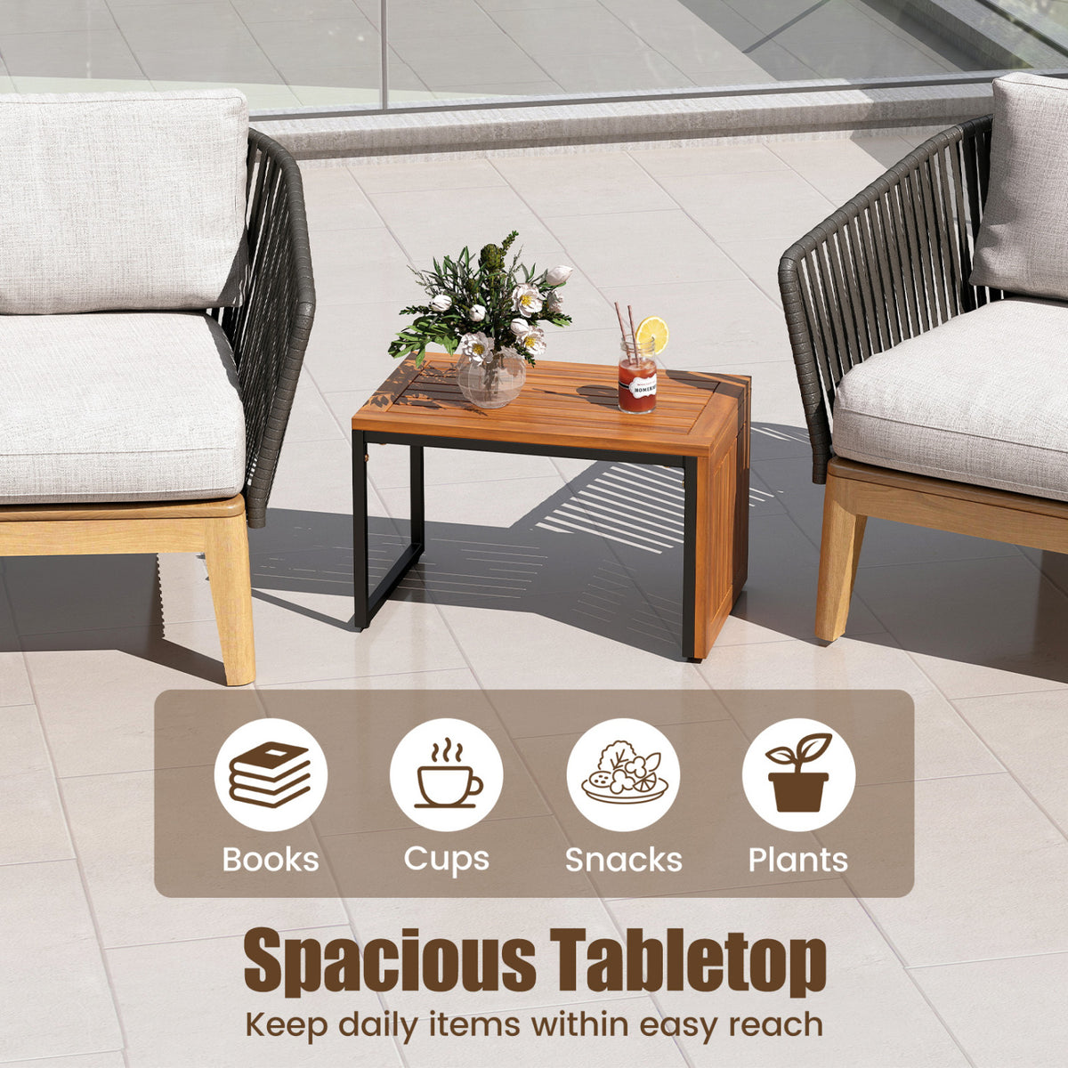 Low wooden table between two patio chairs, topped with a small bouquet and a drink.