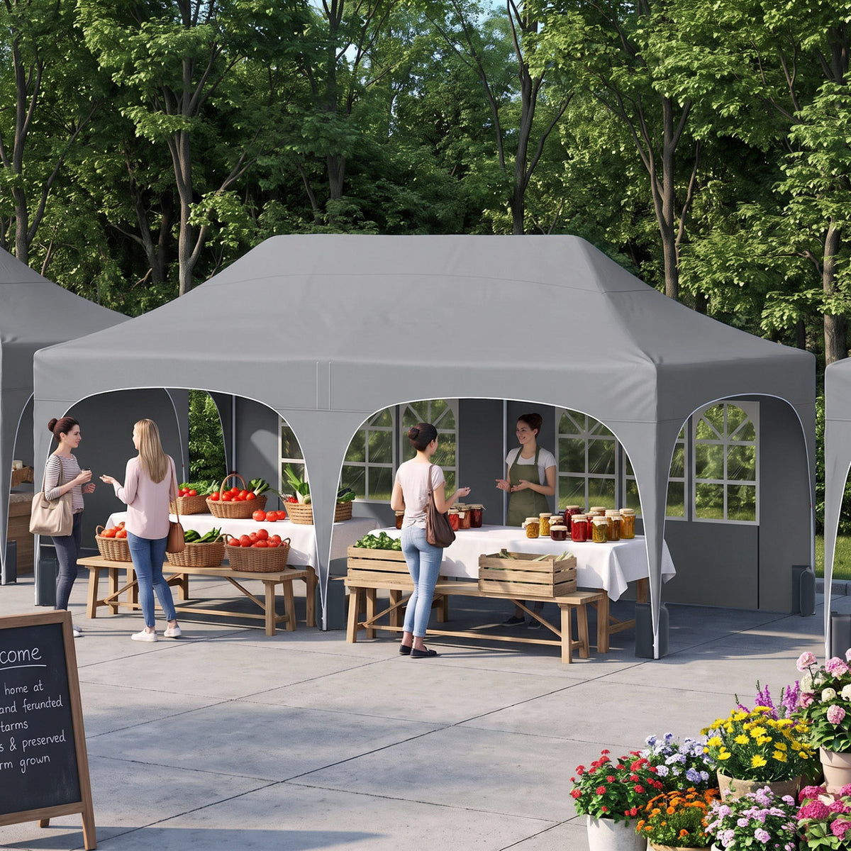 Open-sided white canopy shelters market tables and people on a paved patio beside trees.
