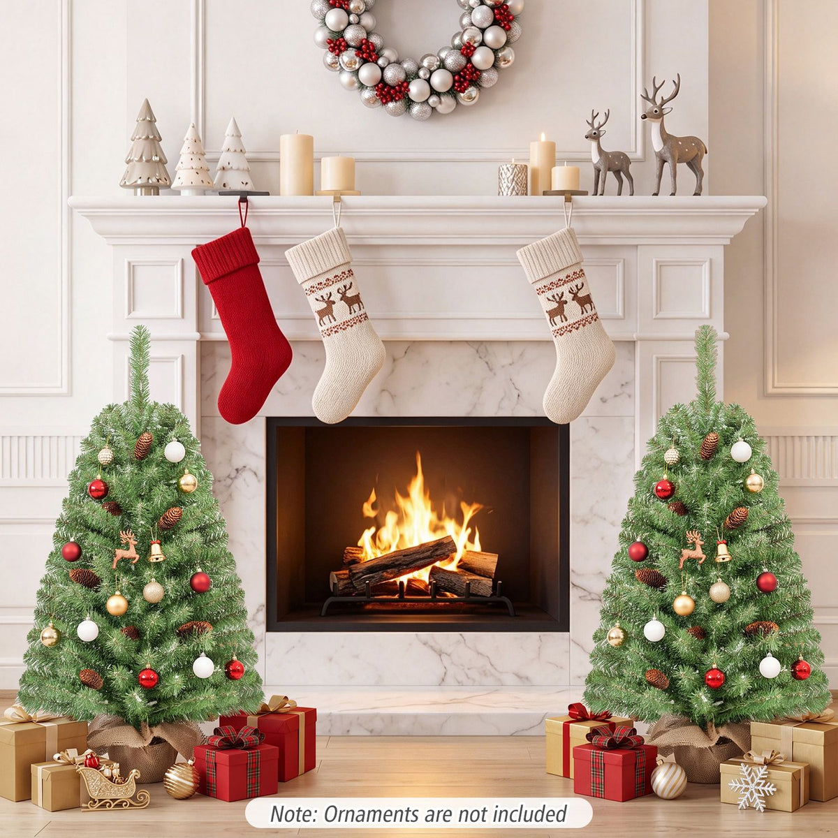 Two decorated mini trees flank a lit fireplace beneath a mantel with stockings and a wreath.