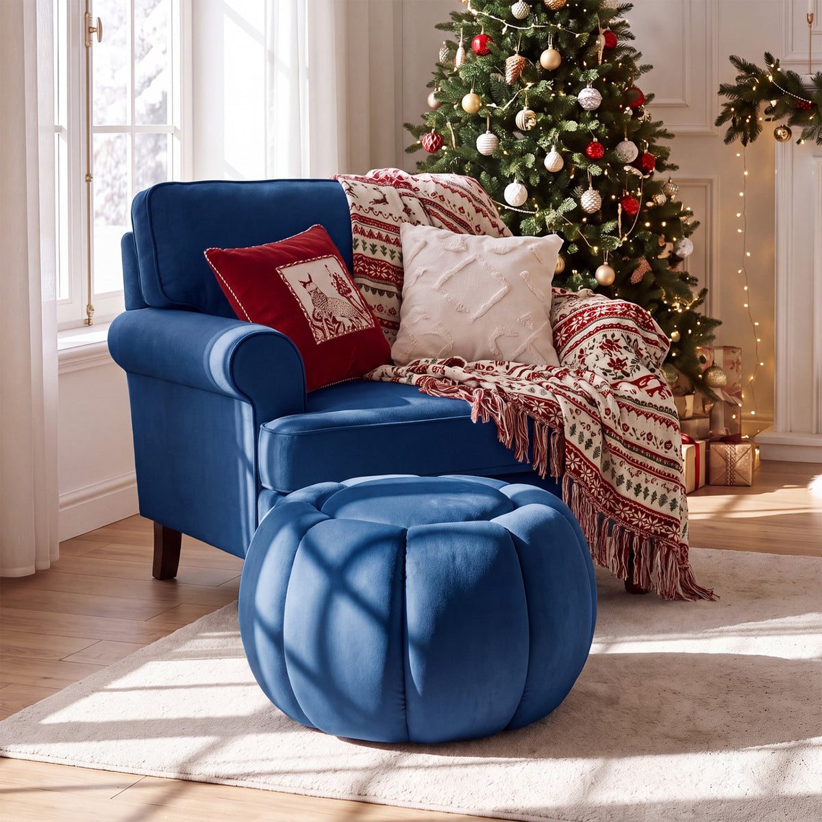 Blue pumpkin-shaped ottoman in front of an armchair beside a decorated Christmas tree.