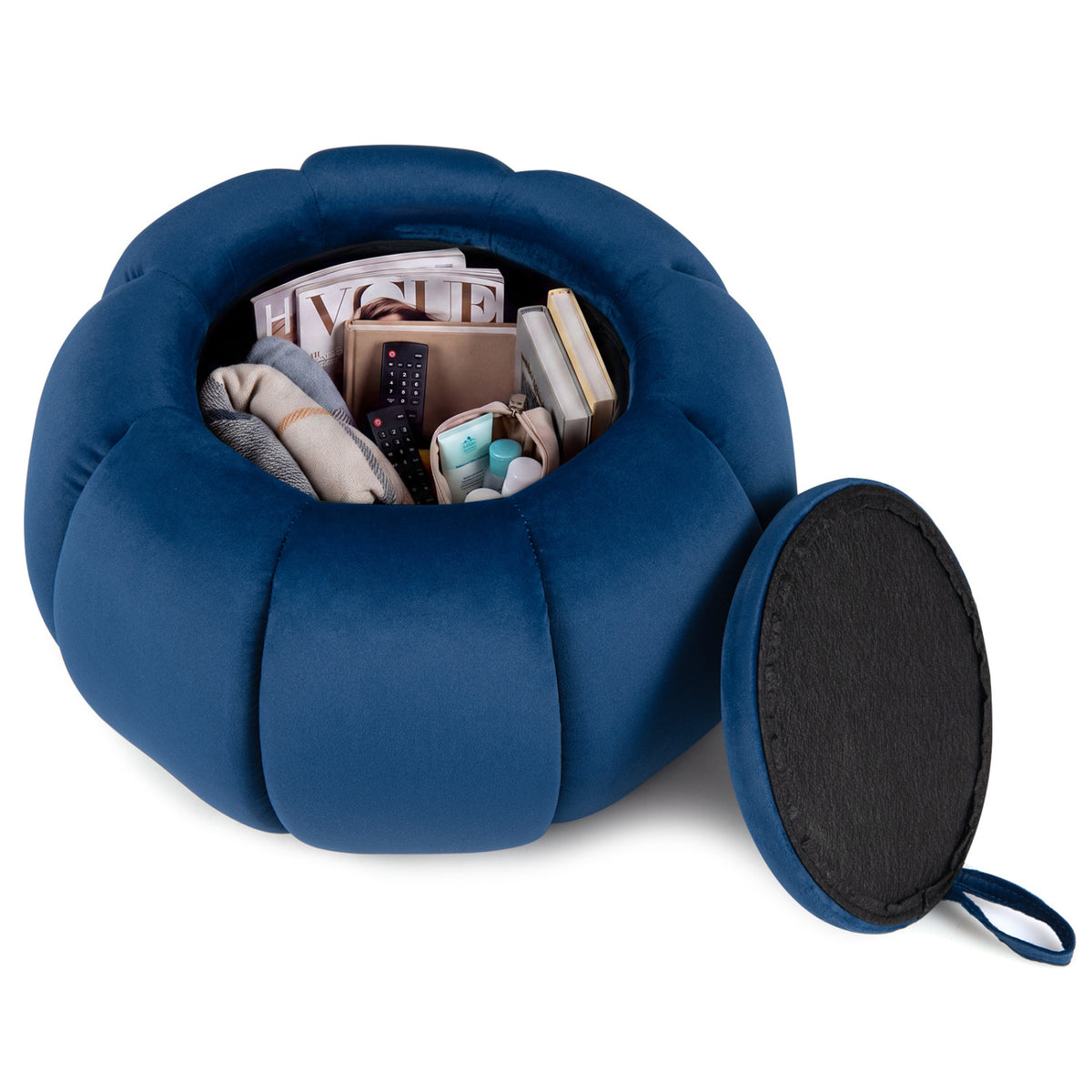 Blue ottoman opened to reveal stored items, with its dark-backed lid leaning beside it.