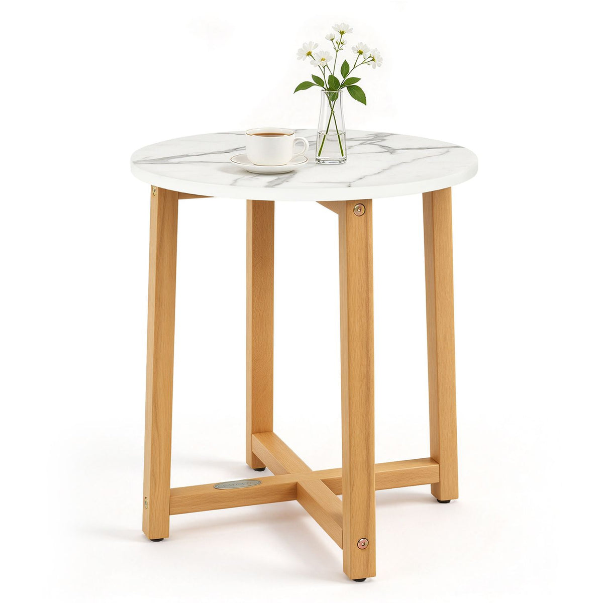 Round veined table styled with a cup and saucer and a small vase of flowers.