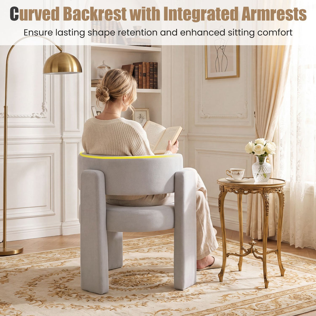 Person seated in a light gray barrel chair, viewed from behind in a room