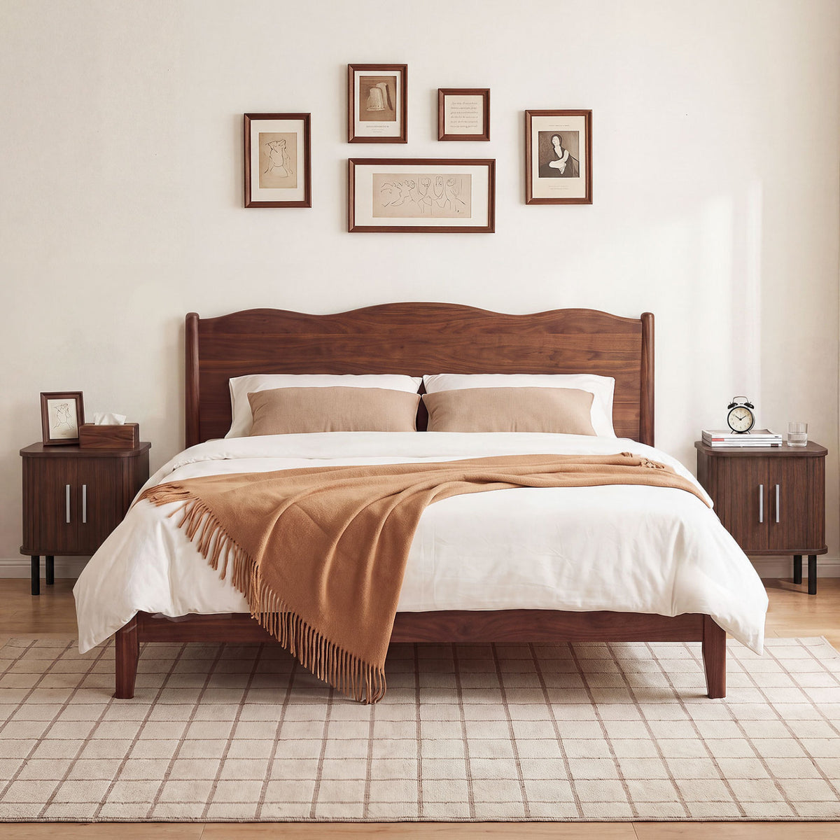 Matching dark nightstands flank a wooden bed with white bedding and a tan throw.