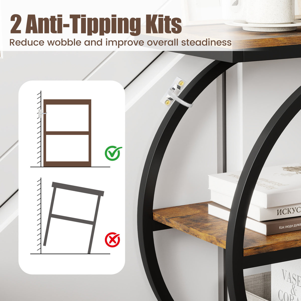 Close-up of a black metal table frame secured to the wall with an anti-tip strap.