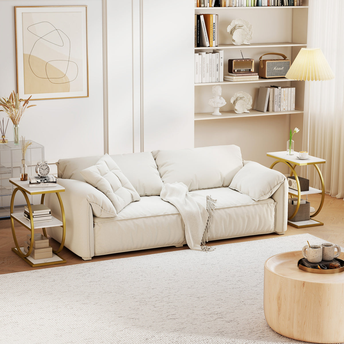 Two gold-framed side tables with white tops flank a cream sofa in a bright living room.