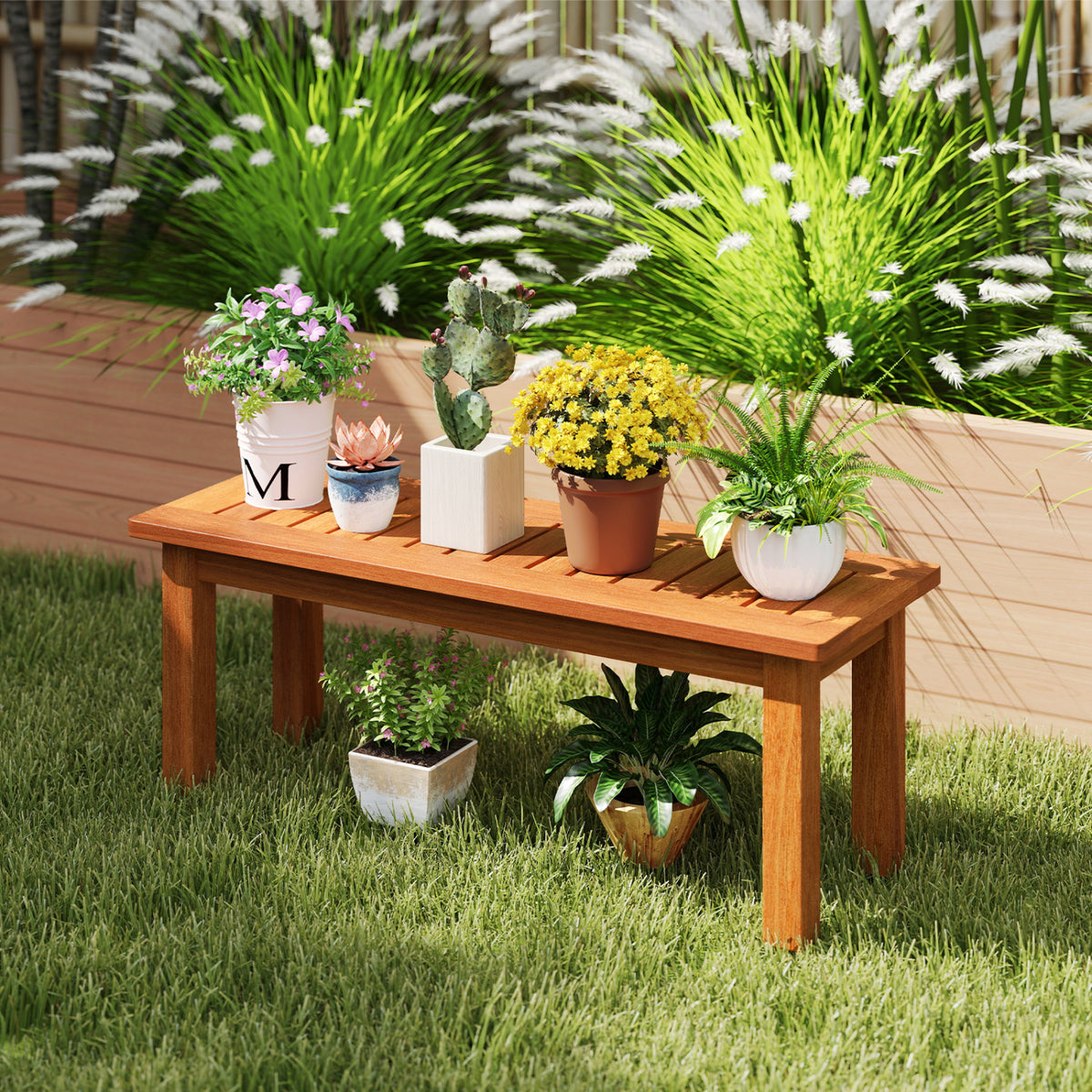 A wooden slatted plant stand on grass, arranged with potted flowers and greenery.