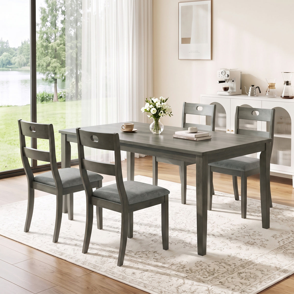 Gray wooden chairs around a rectangular dining table in a bright room with a large window.