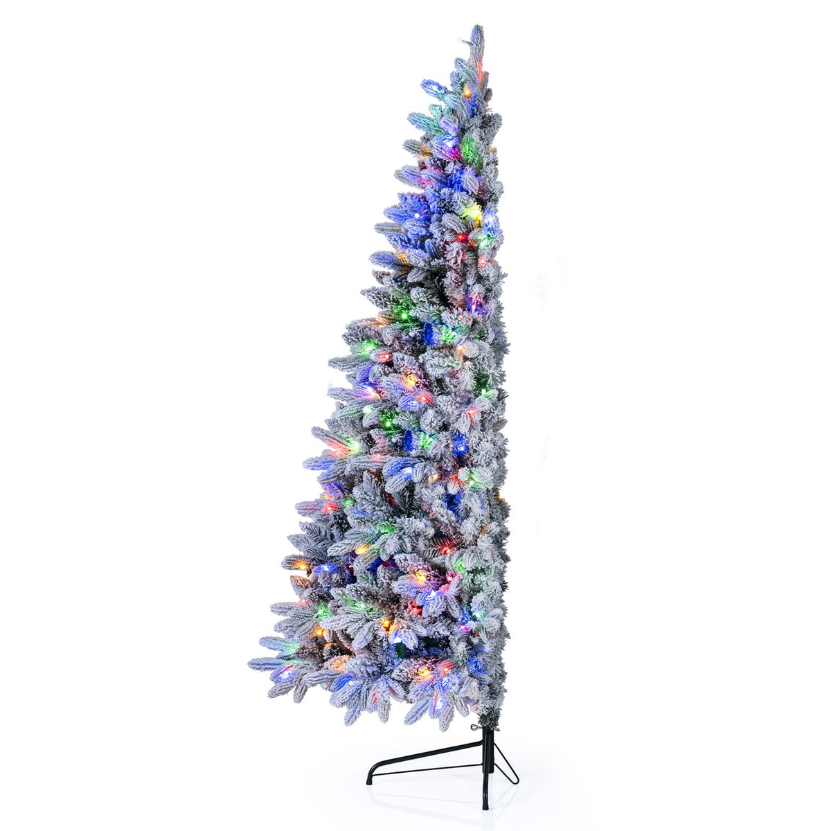 Narrow side profile of a snow-flocked half tree glowing with multicolored lights.