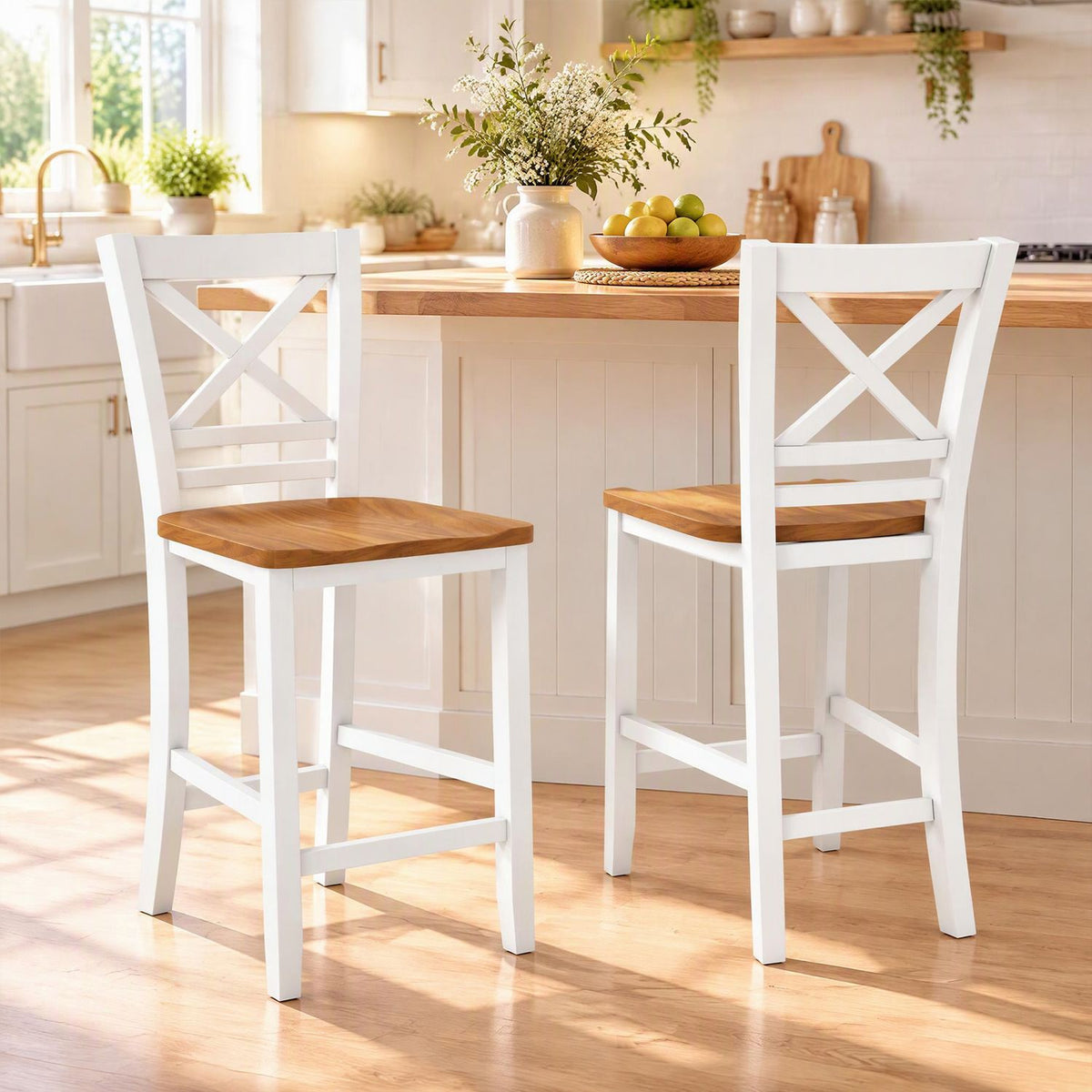 Two white cross-back stools with brown seats stand at a kitchen island.