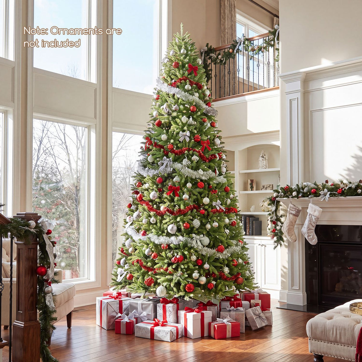 Decorated green Christmas tree with red and silver ornaments beside tall windows and a fireplace.