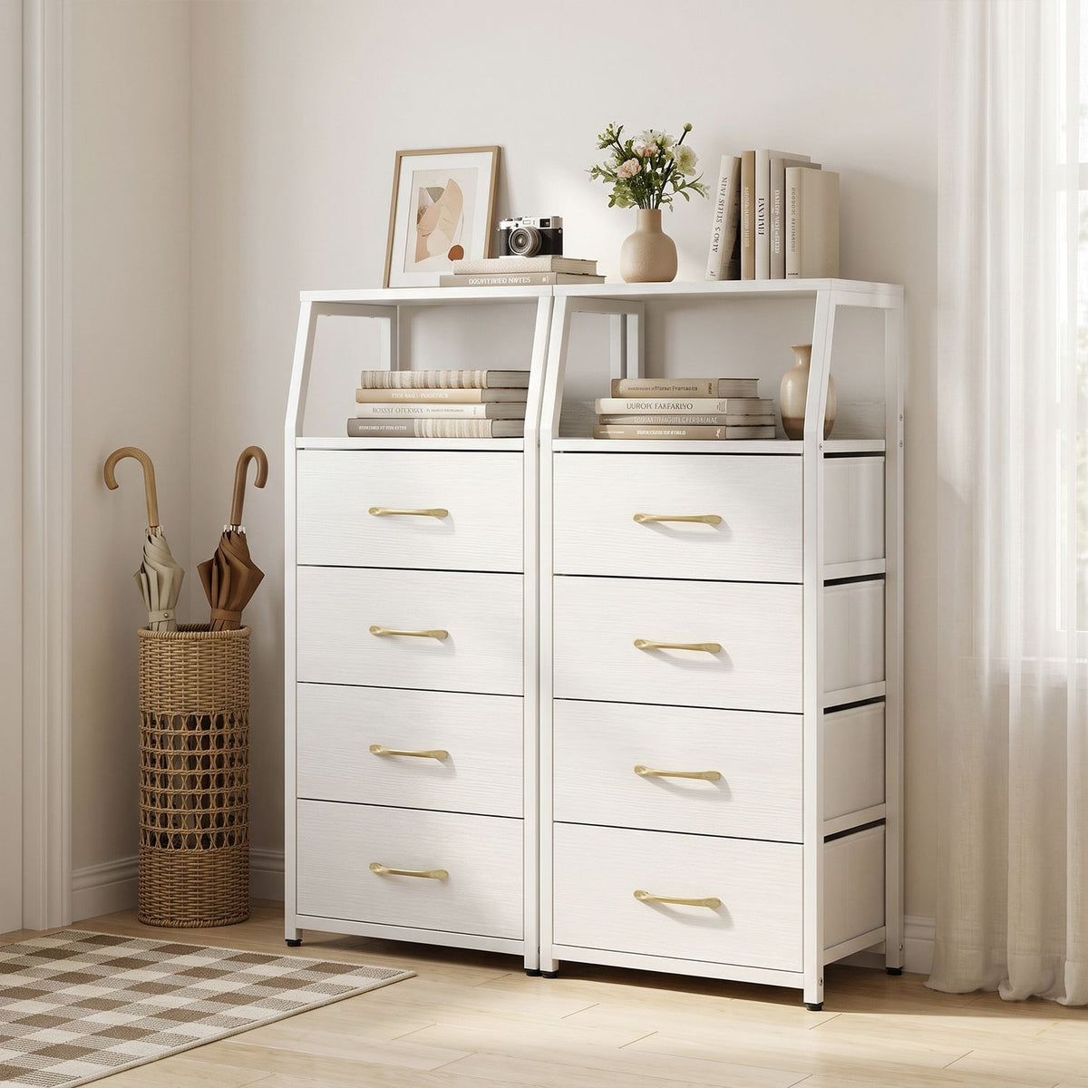 White fabric-drawer dresser with open shelves styled beside a window, with books and decor on top.