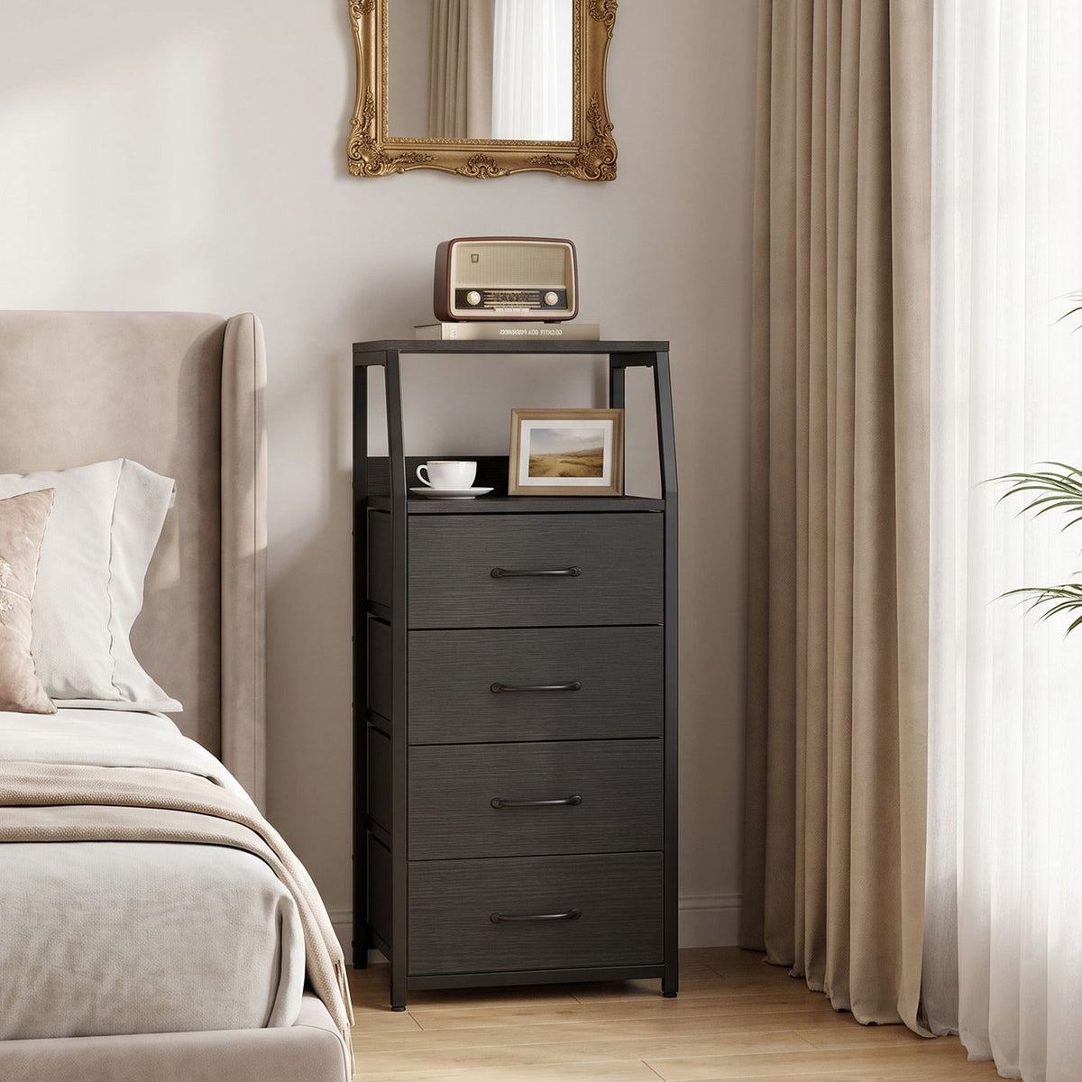Dark fabric-drawer dresser beside a bed, with decor on its top and open shelf.