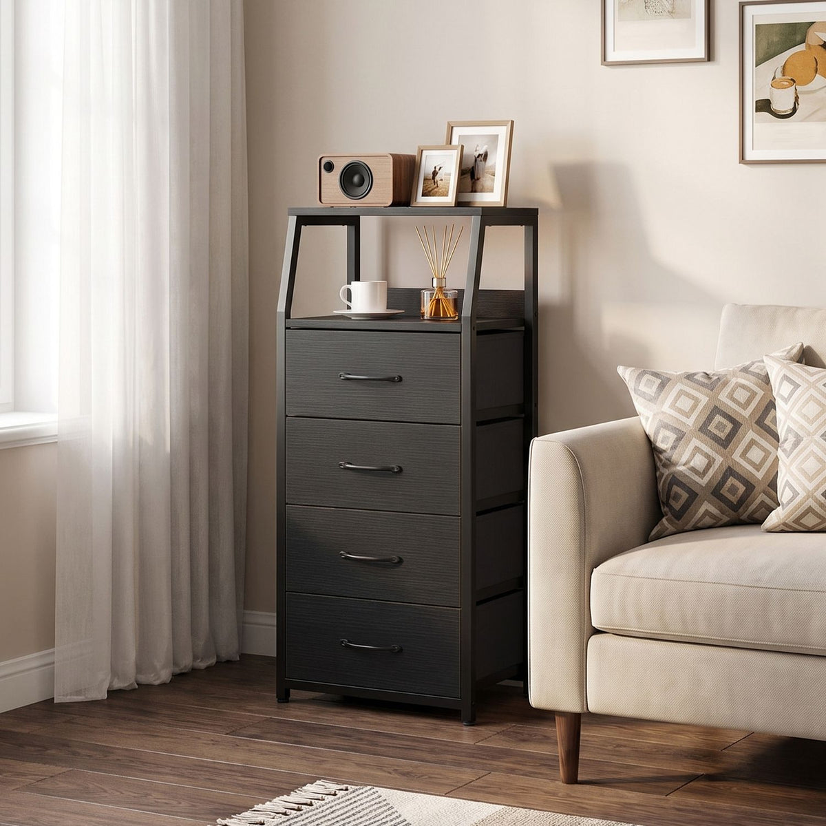 Dark fabric-drawer dresser styled beside a sofa, shown from a slight angle.