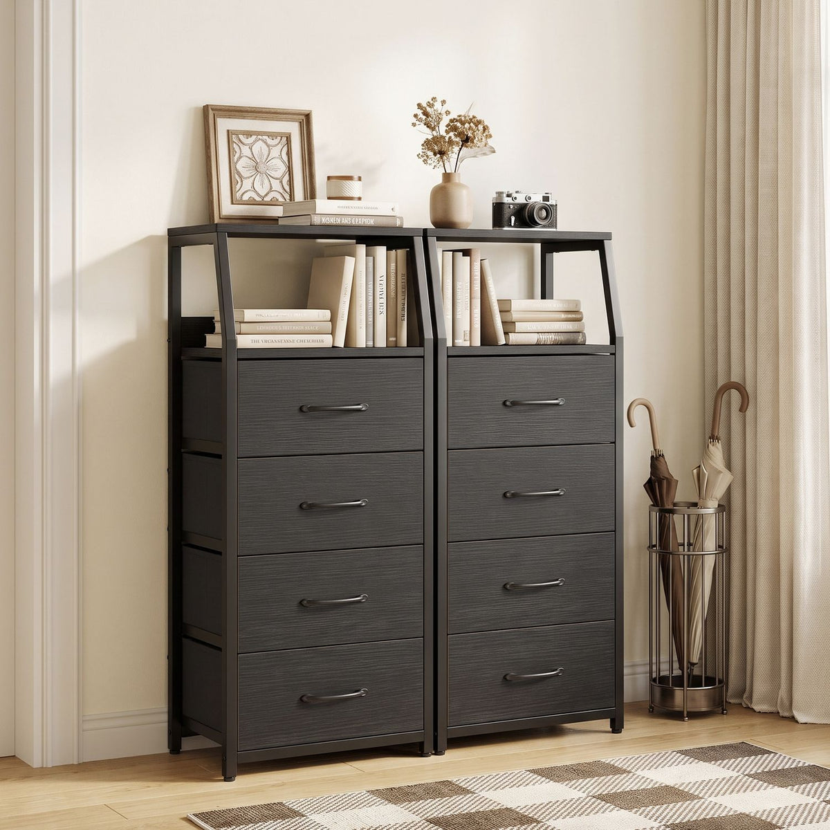 Two dark fabric-drawer dressers with open upper shelves stand side by side against a light wall.