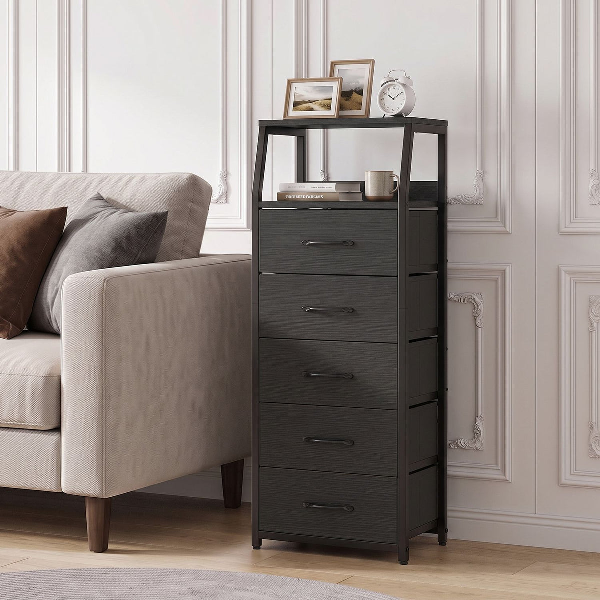 Black fabric-drawer dresser beside a sofa, with framed photos and a clock on its top shelf.