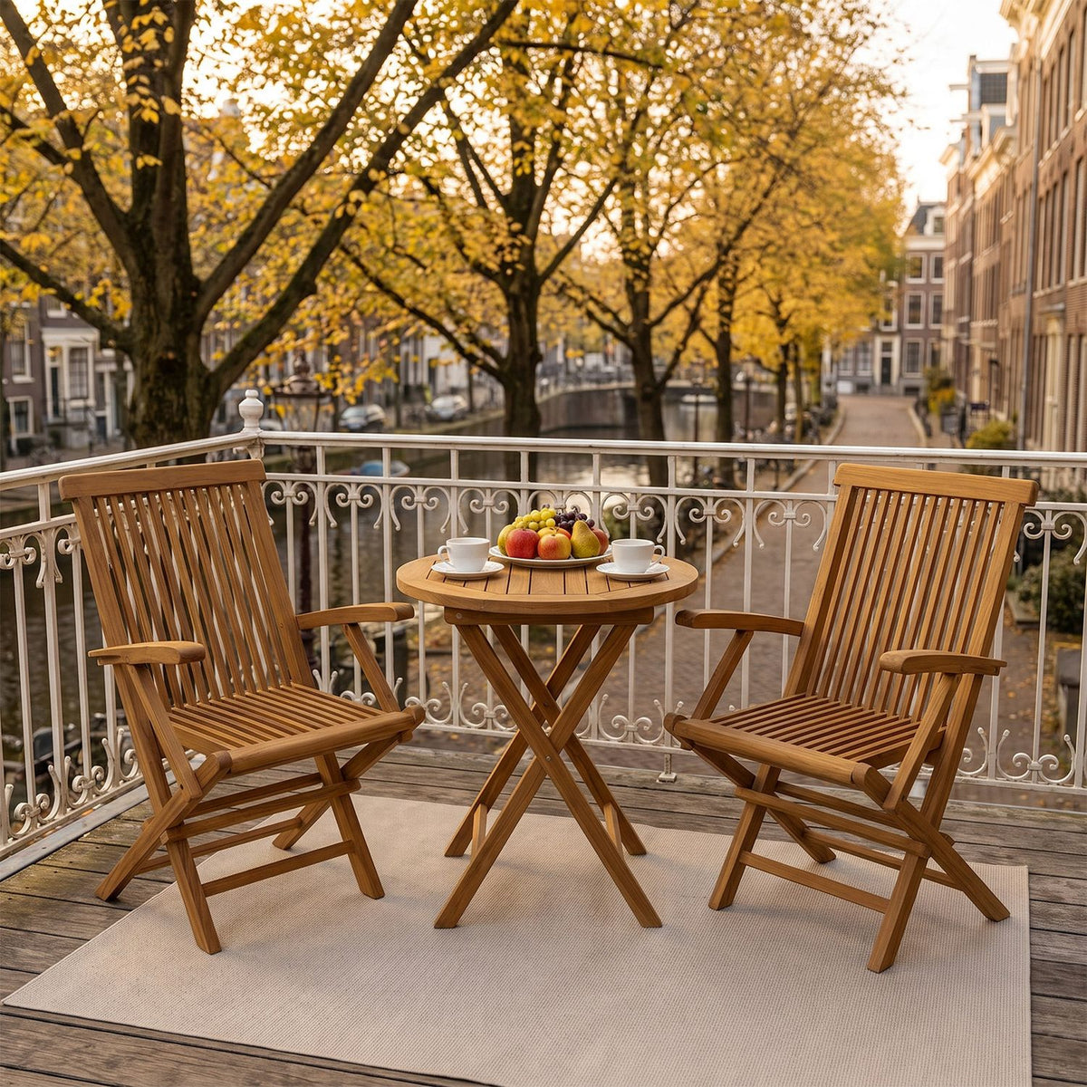 Two wooden folding chairs flank a small round table on a balcony.
