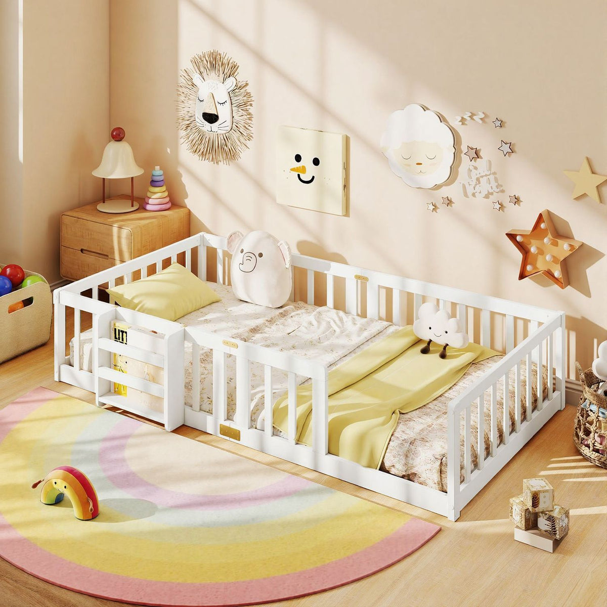 White floor bed with safety rails and a small side bookshelf, dressed in yellow and cream bedding in a sunny nursery.