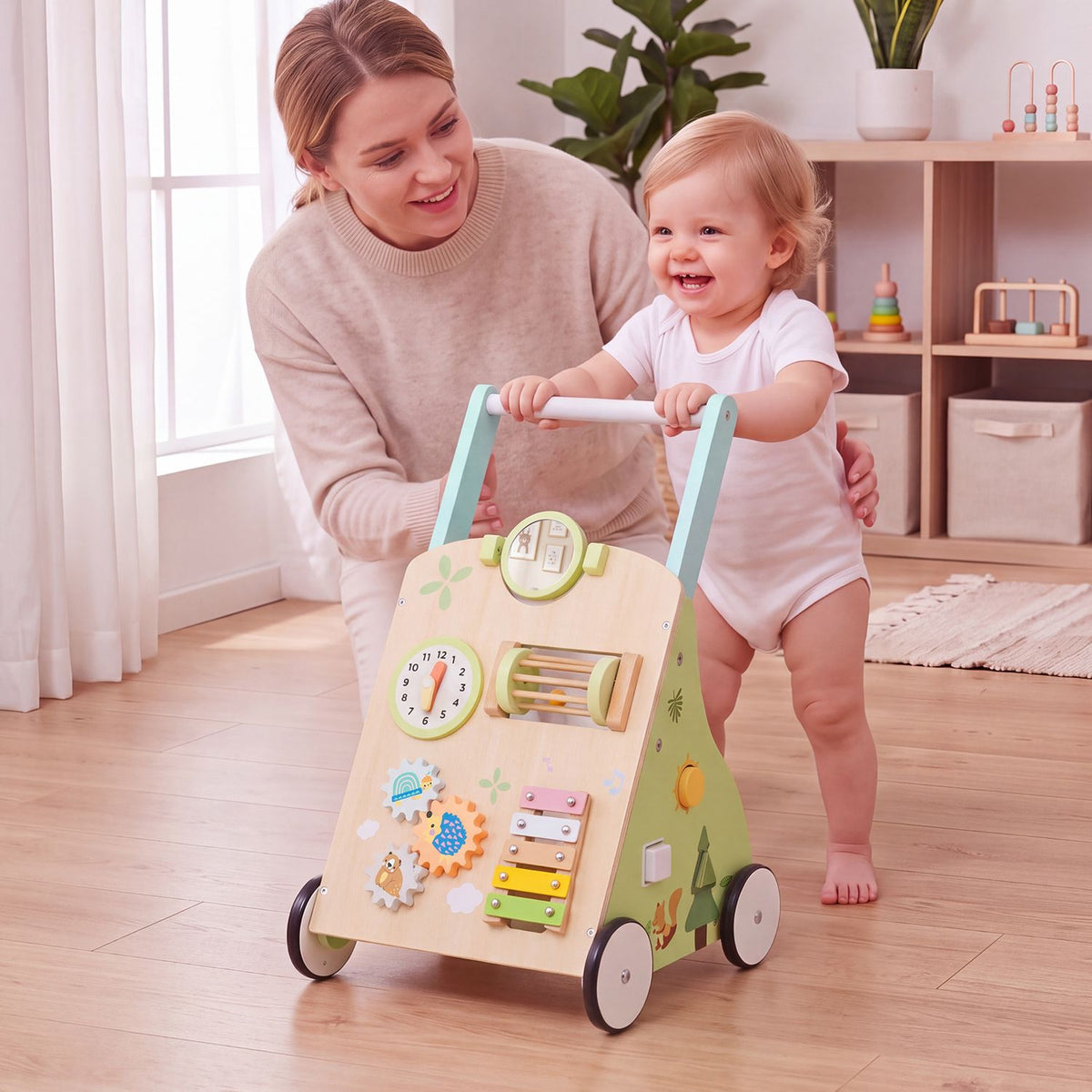 A smiling toddler holds the walker handle while an adult supports them in a bright nursery.
