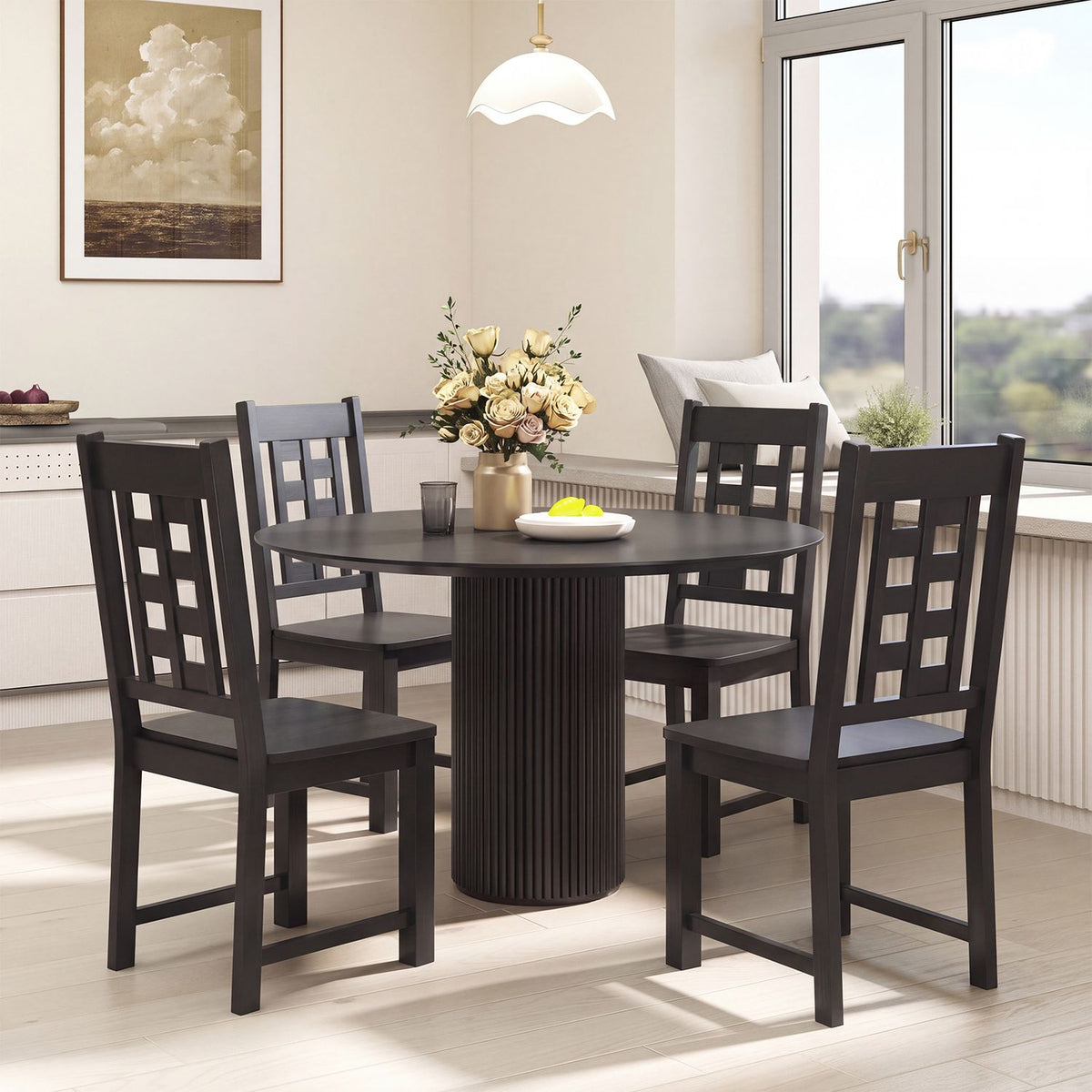 Four dark wooden chairs arranged around a round dining table in a bright dining room.