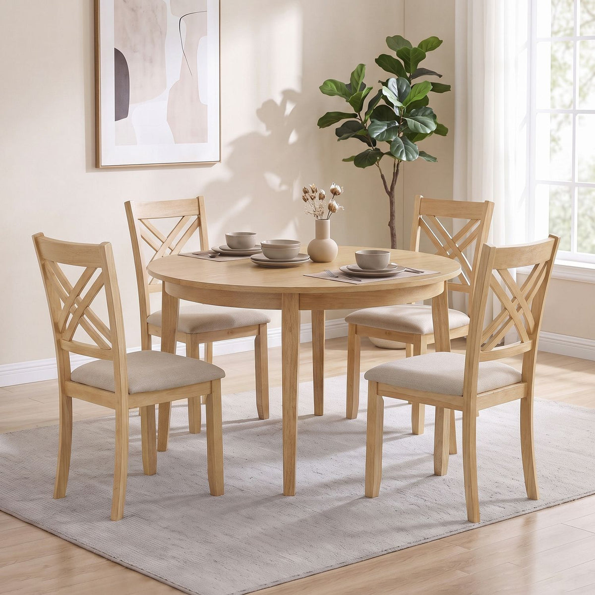 Four light wood chairs with pale upholstered seats surround a round dining table in a bright room.