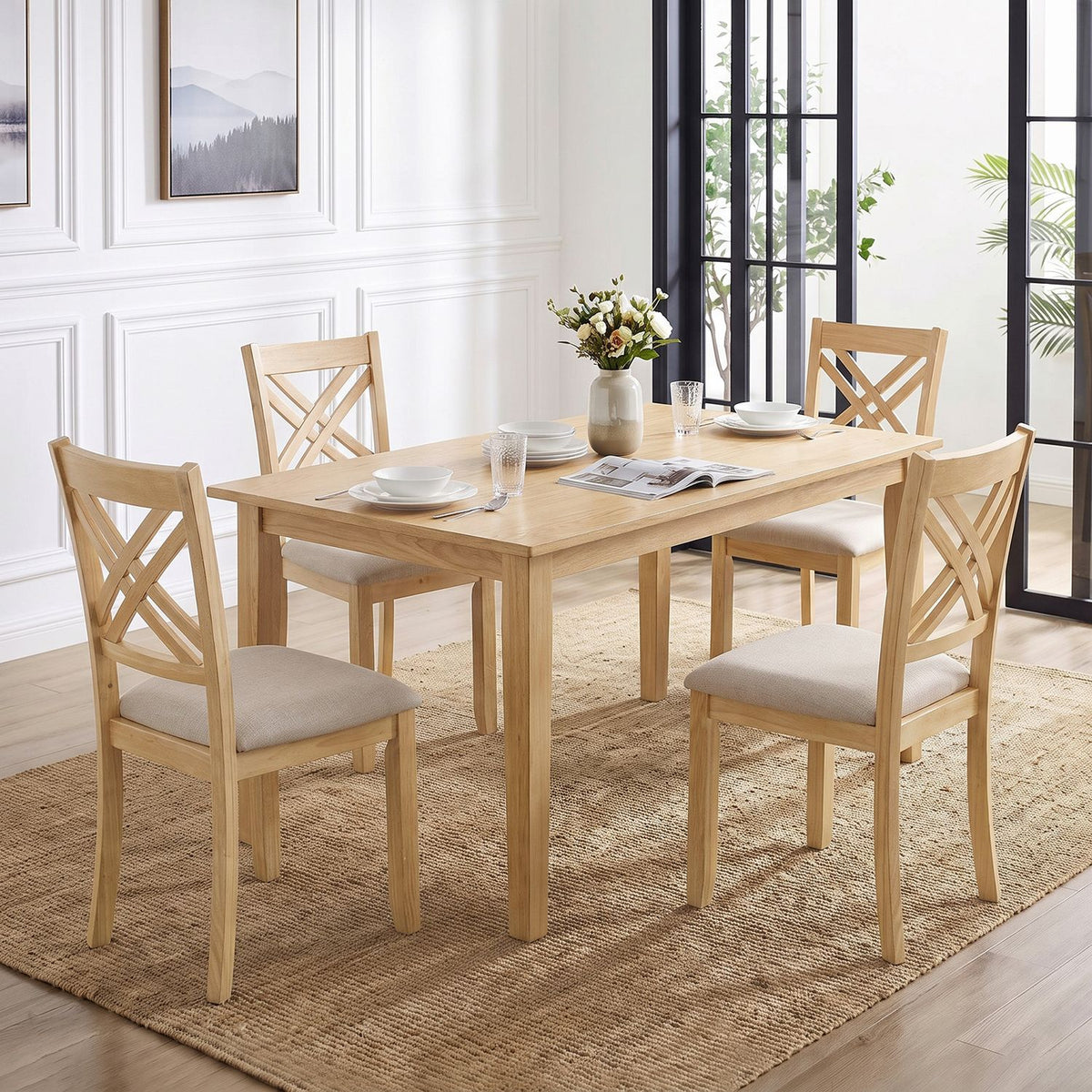 Four light wood dining chairs with pale upholstered seats surround a matching table in a bright dining room.