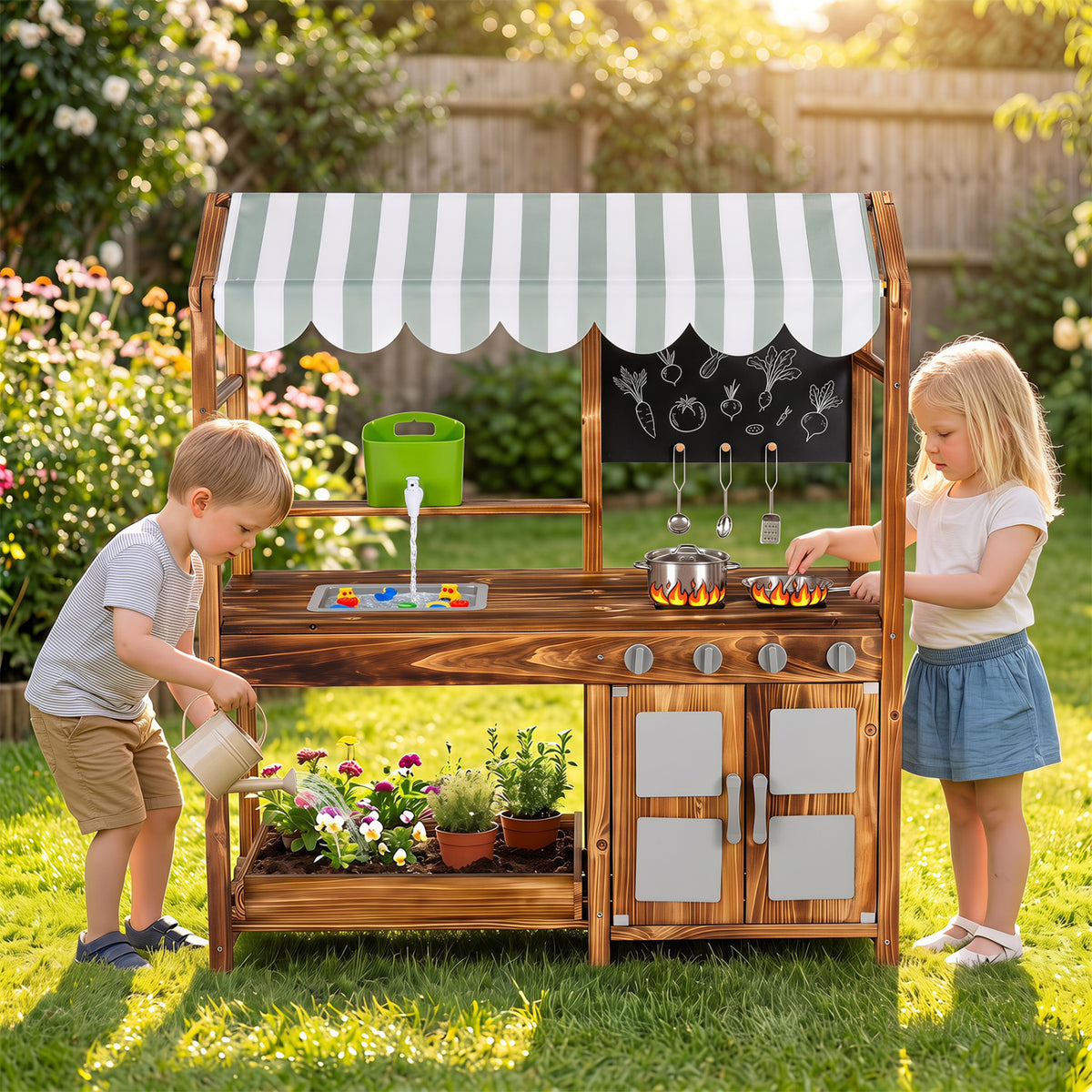 Two children play at a wooden outdoor kitchen beneath a striped canopy.