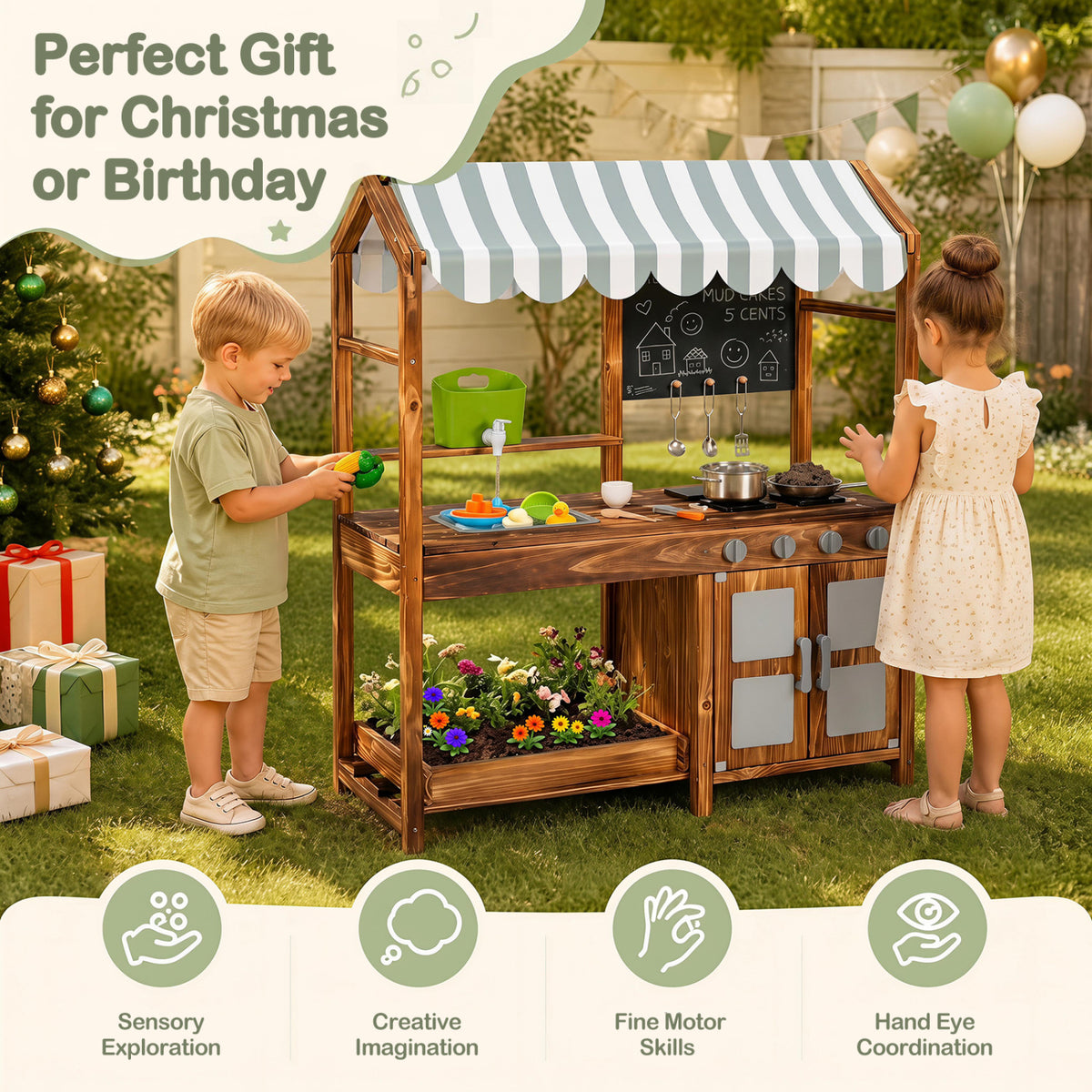 Two children play at a wooden kitchen with a striped canopy in a garden decorated for the holidays.