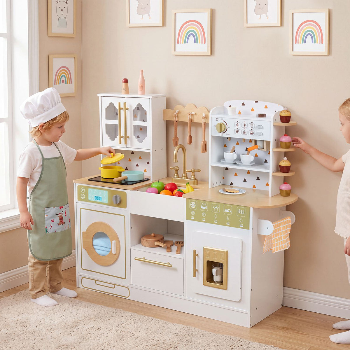 A child reaches toward a pot on the toy stove while another offers a cupcake beside the kitchen.